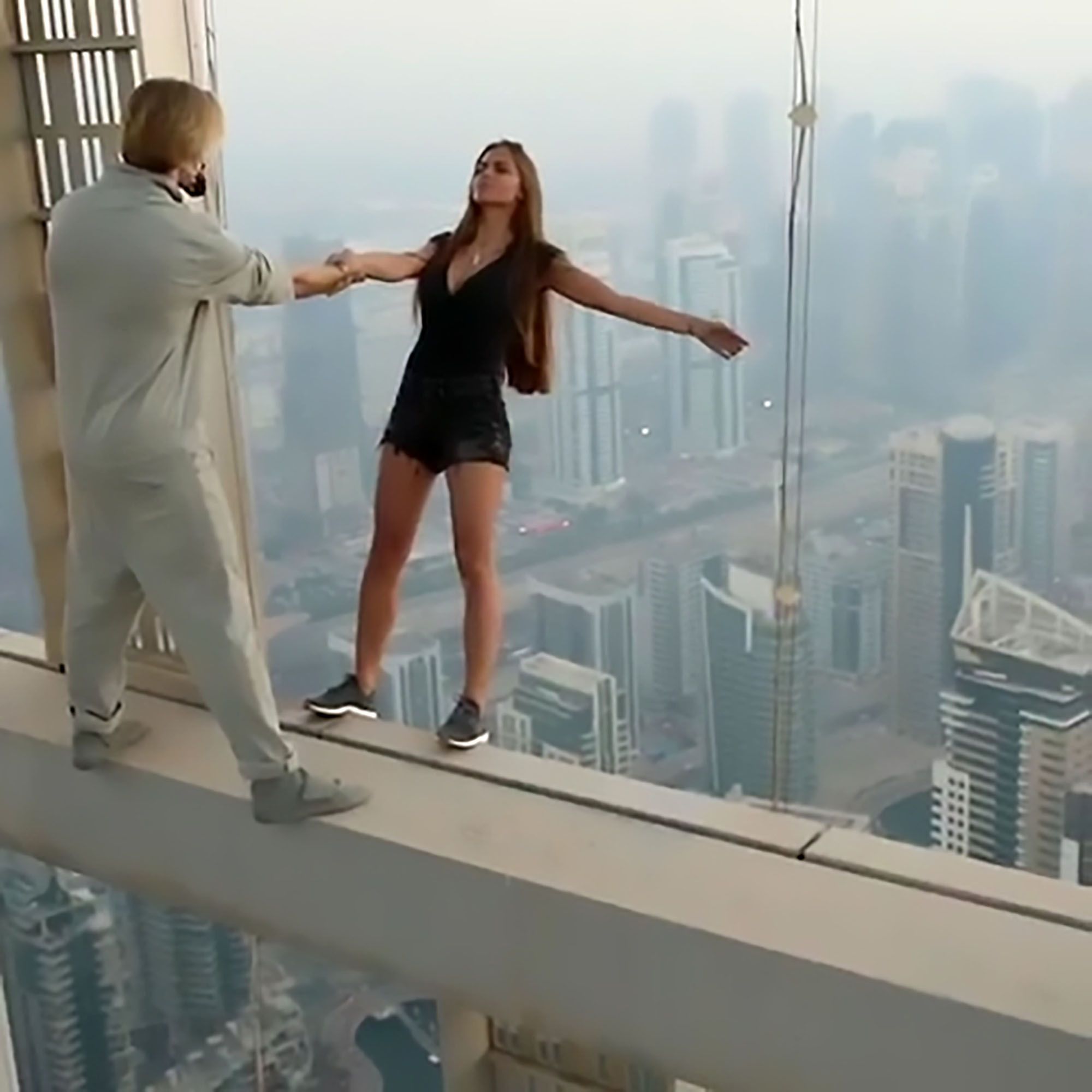 2000x2000 Russian model risks her life by dangling off a 307 metre skyscraper for the perfect picture