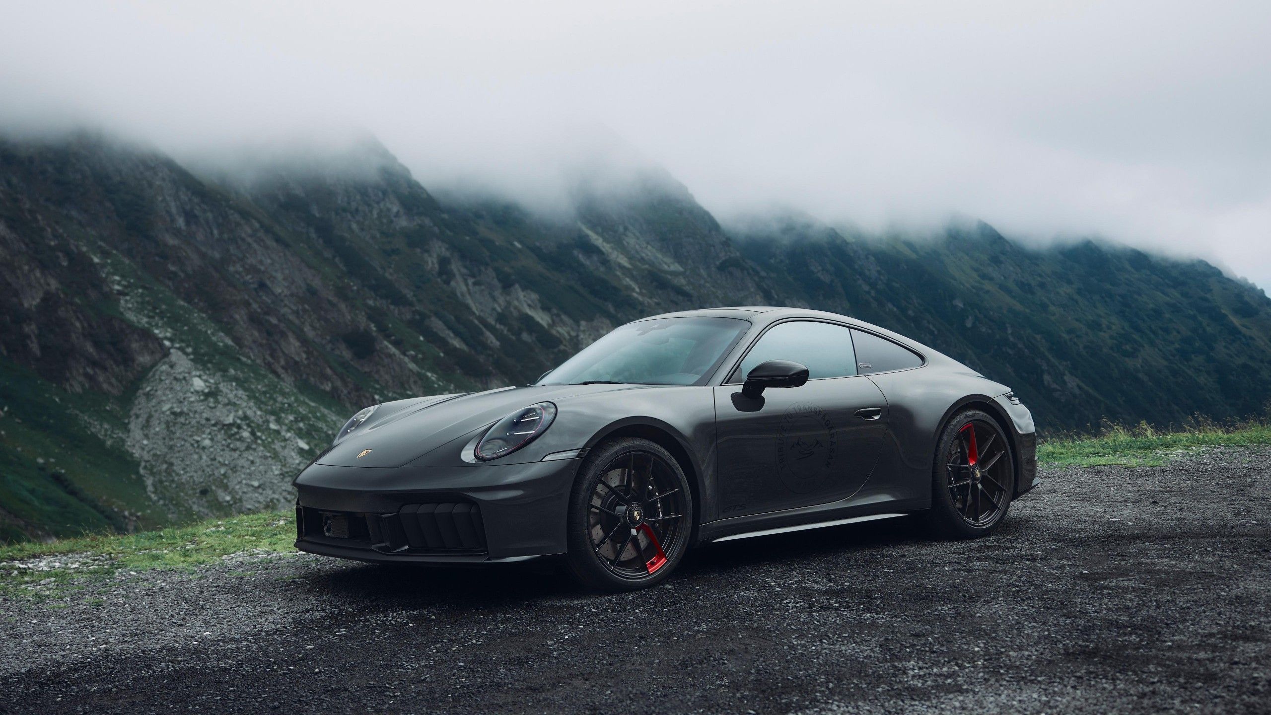 2560x1440 Porsche 911 Carrera 4 GTS Tribute to Transfagarasan 2025 black car 4K 5K HD Cars Wallpaper