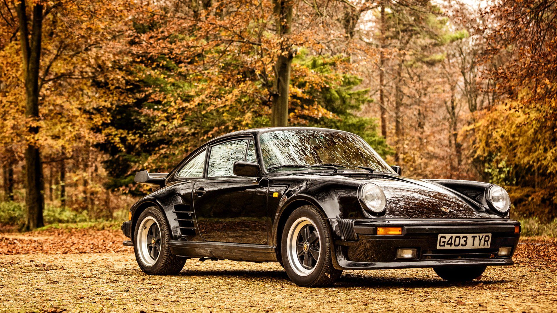 1920x1080 Sleek Black Porsche 911: Stunning HD Wallpaper in Autumn Surroundingsx1080