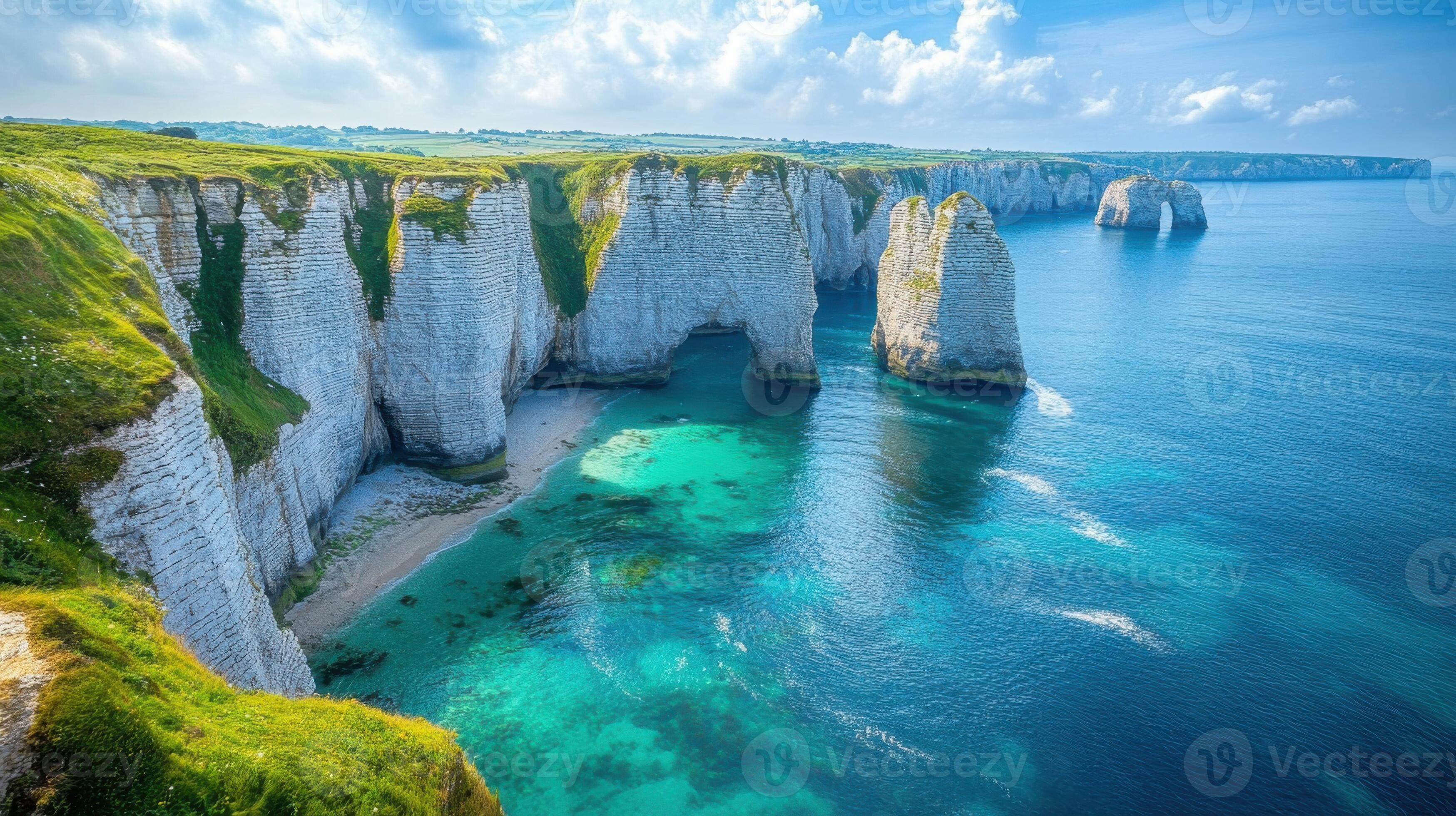 3497x1960 Coastal cliffs view. Ocean water. White rock formations along the sea. Green grass on top of the cliffs. Natural landscape in summer