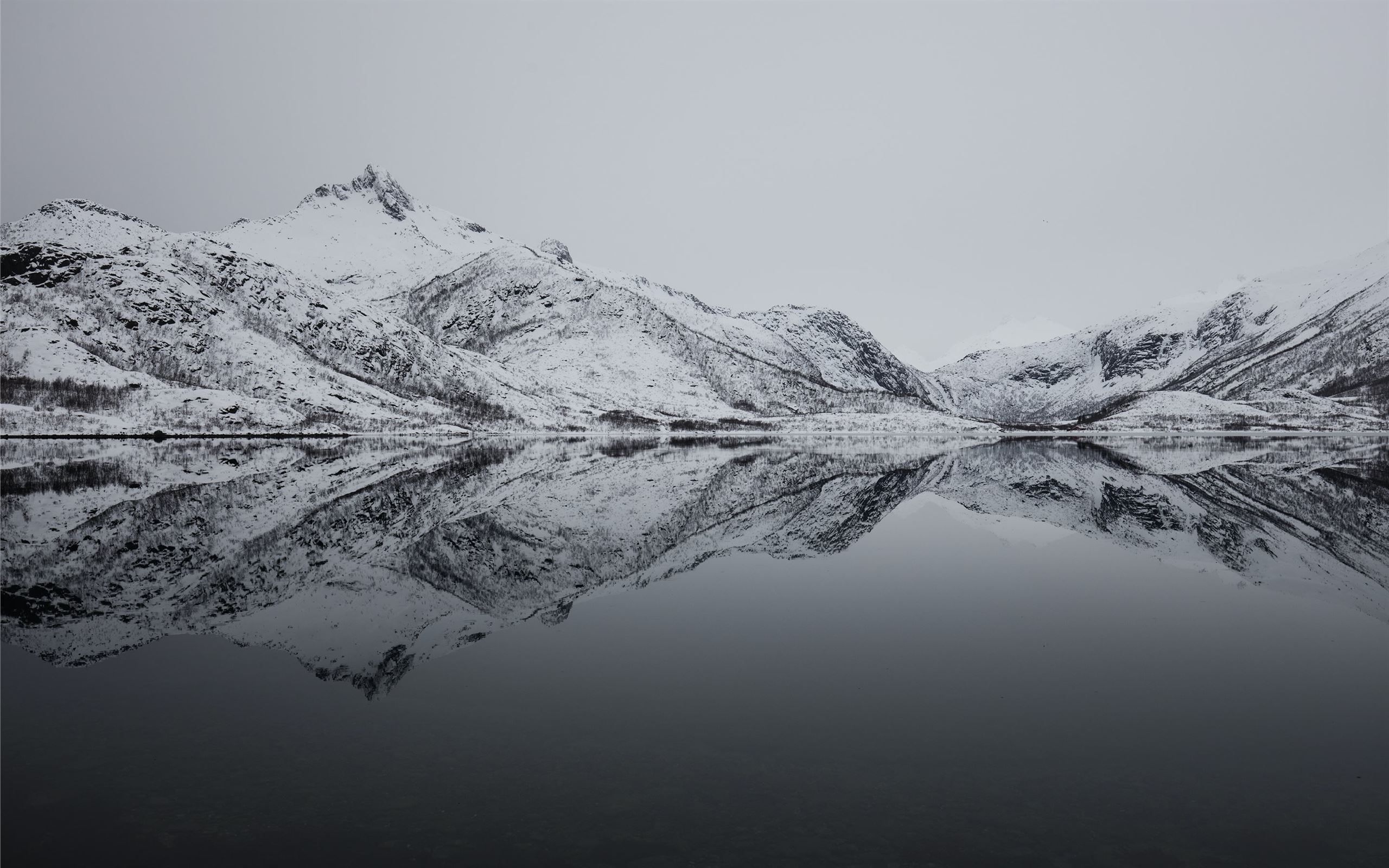 2560x1600 black and white mountain filled with snow near lak MacBook Air Wallpaper Download