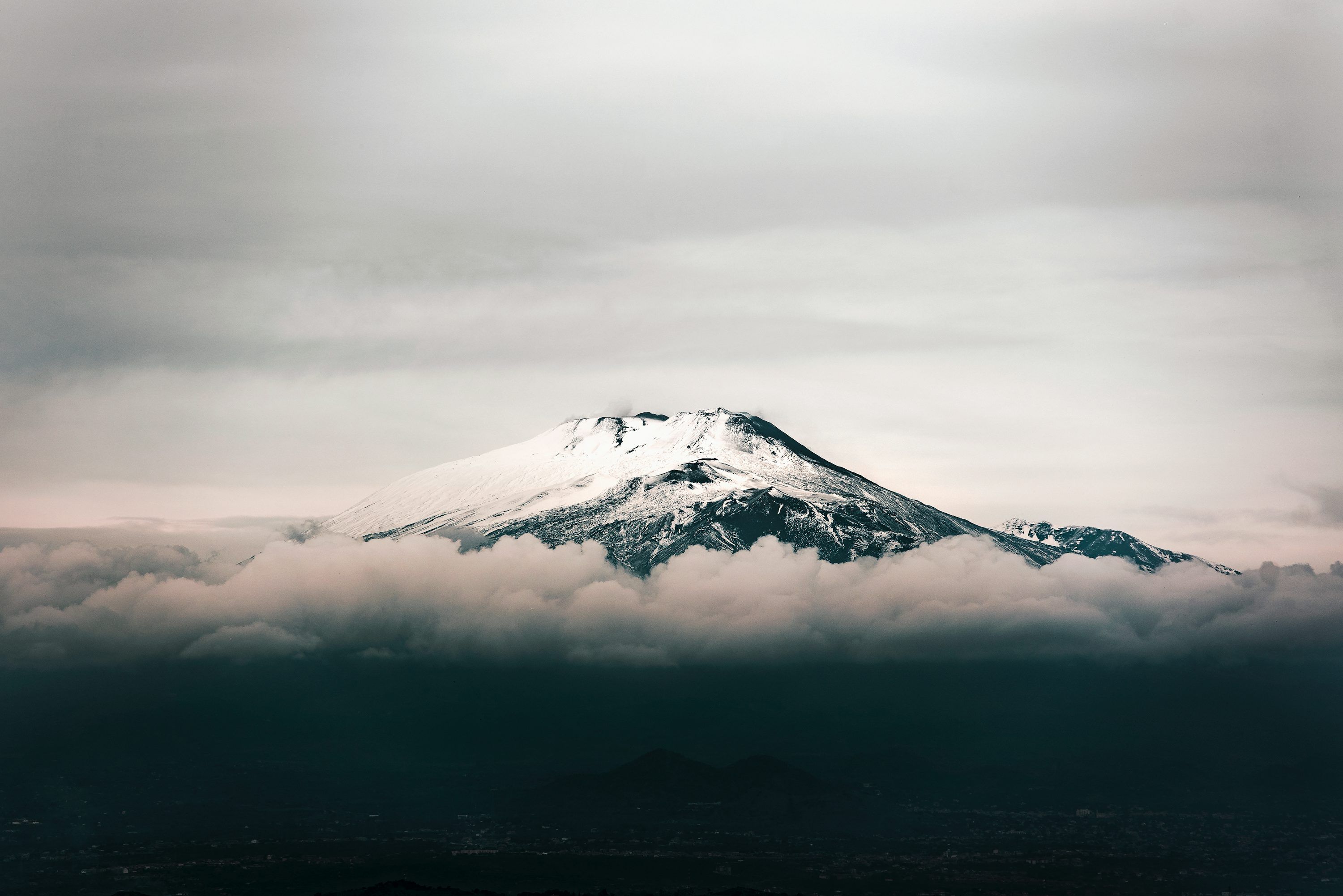 3000x2003 Black mountain covered with snow under grey sky photo
