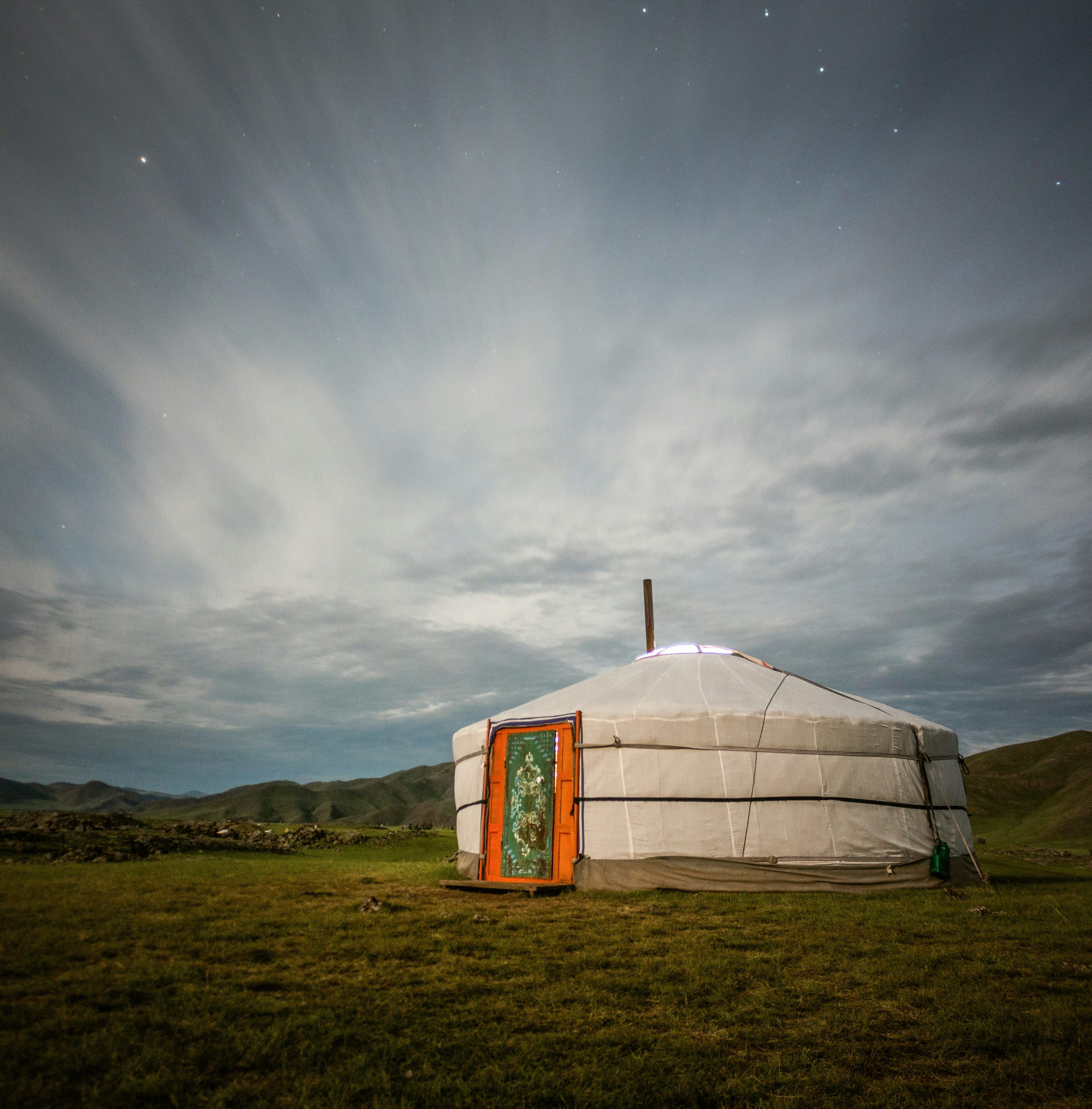 3000x3047 A yurt in the middle of a grassy field photo