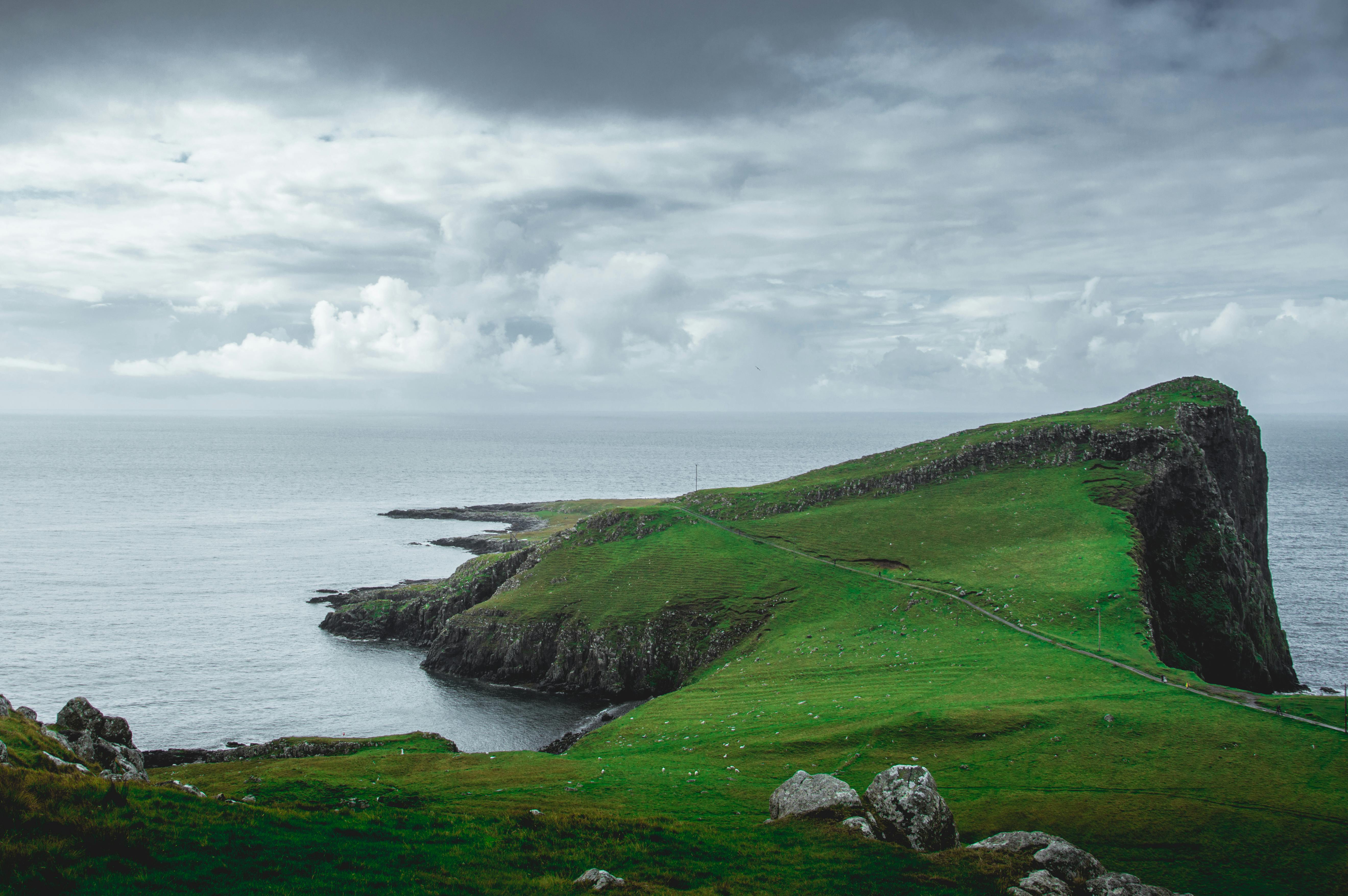 5280x3511 Lighthouse on Near Body of Water Between Rock Formation · Free