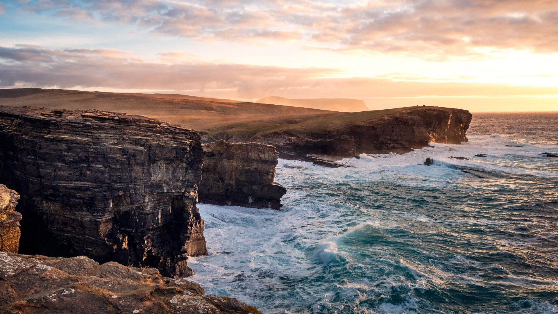 1920x1080 Dramatic waves and cliffs with sunset background, Orkney Islands, Scotland, UK. Windows Spotlight Image