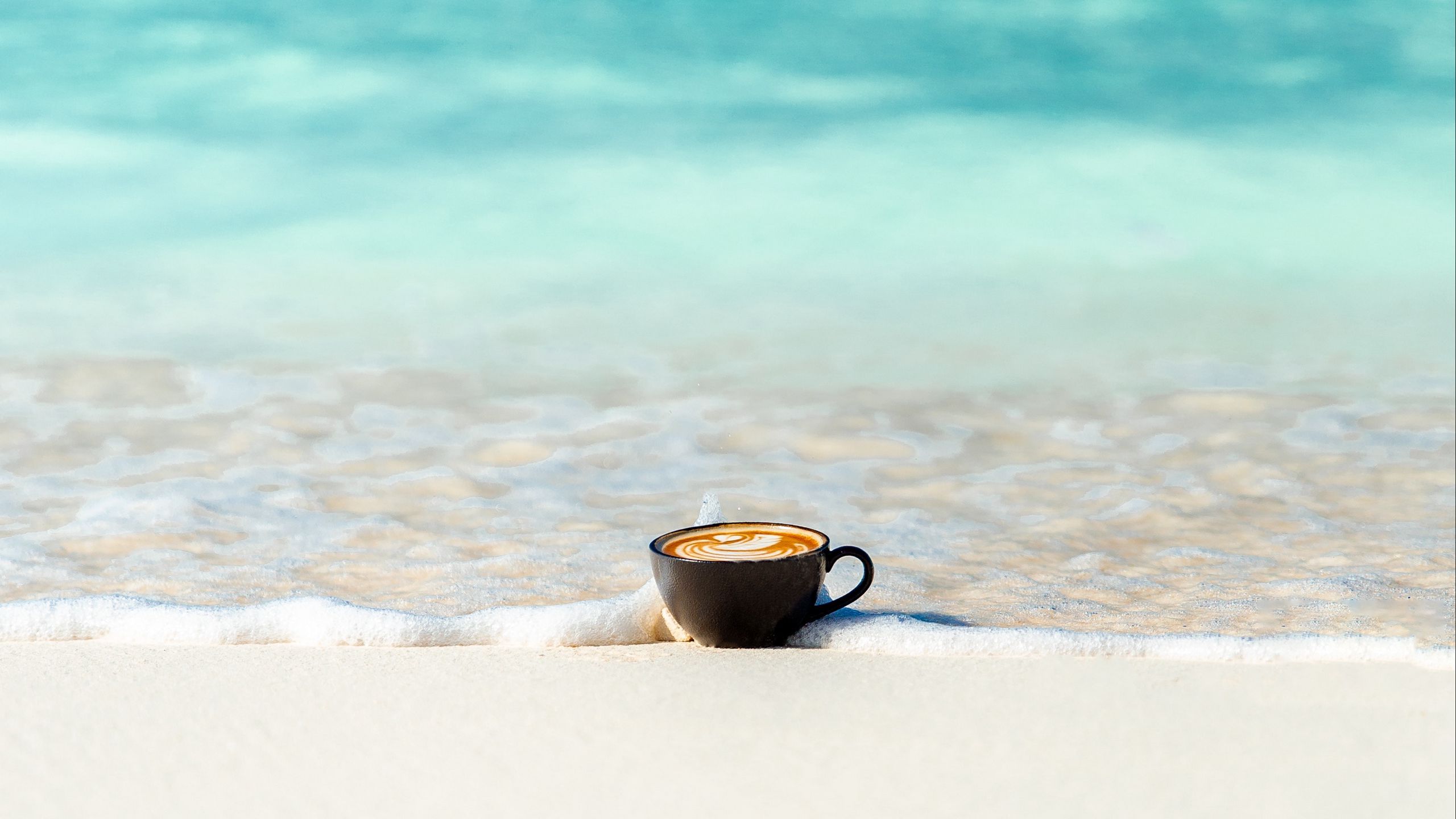 2560x1440 Cup With Coffee On Ocean Sand HD Minimalist Wallpaper