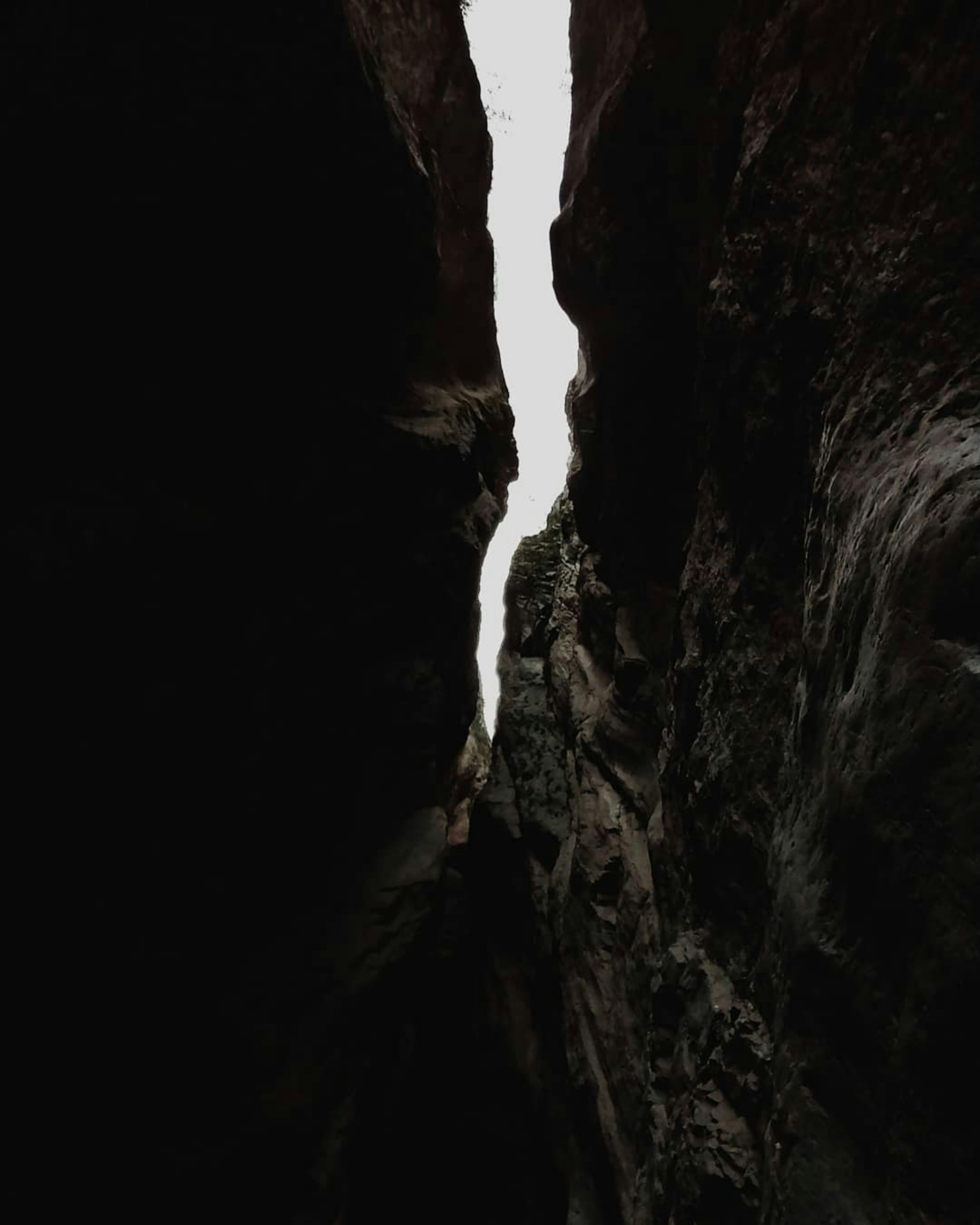 6554x8192 Person Standing in Muddy Cave Entrance · Free