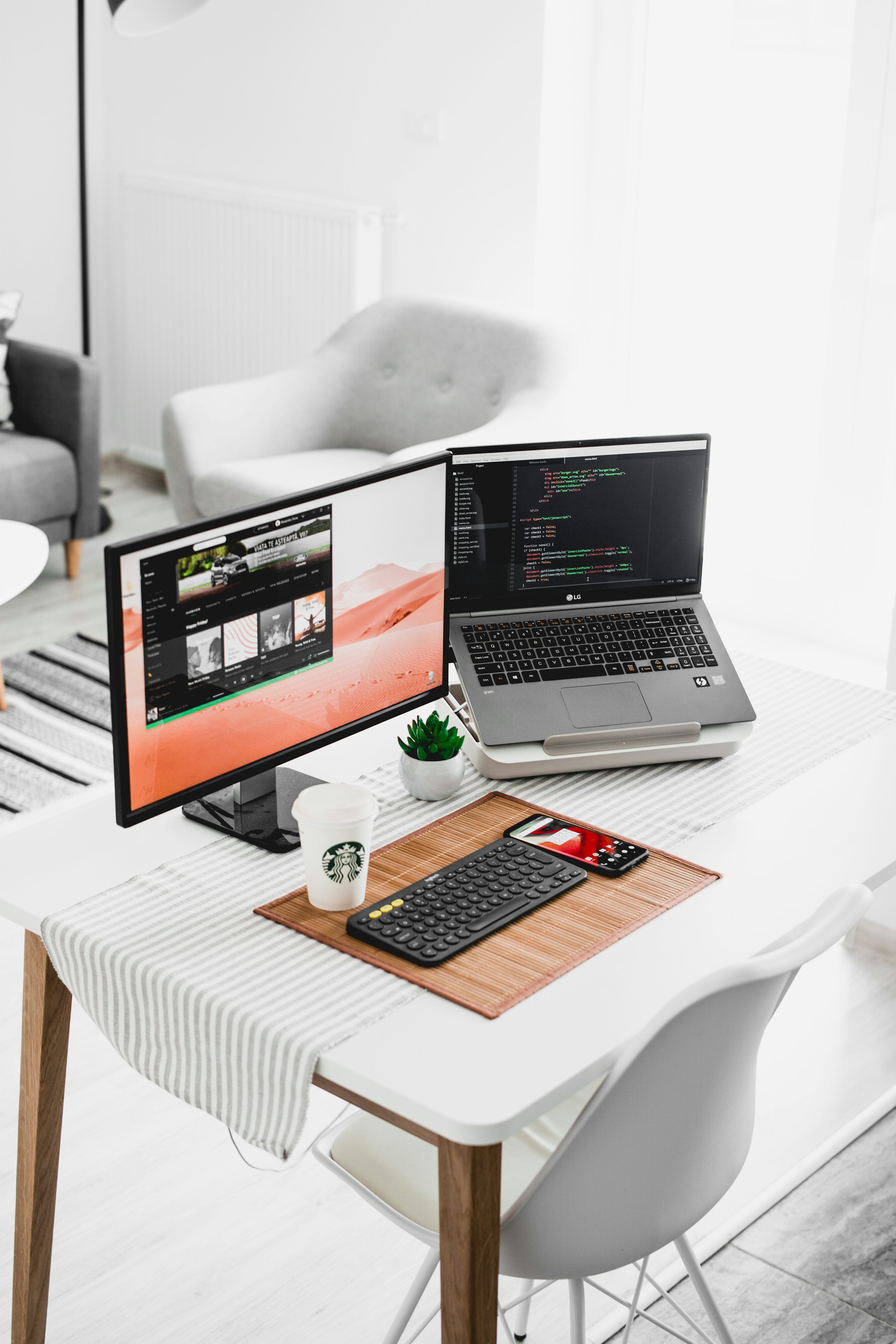 3000x4500 Black flat screen computer monitor and laptop on table photo