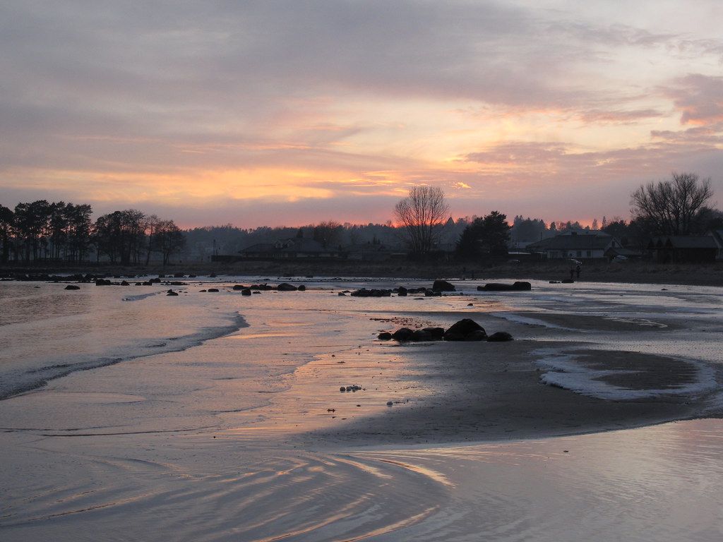 1024x768 Ringshaug beach. Cold sea water washes up on the ice covere