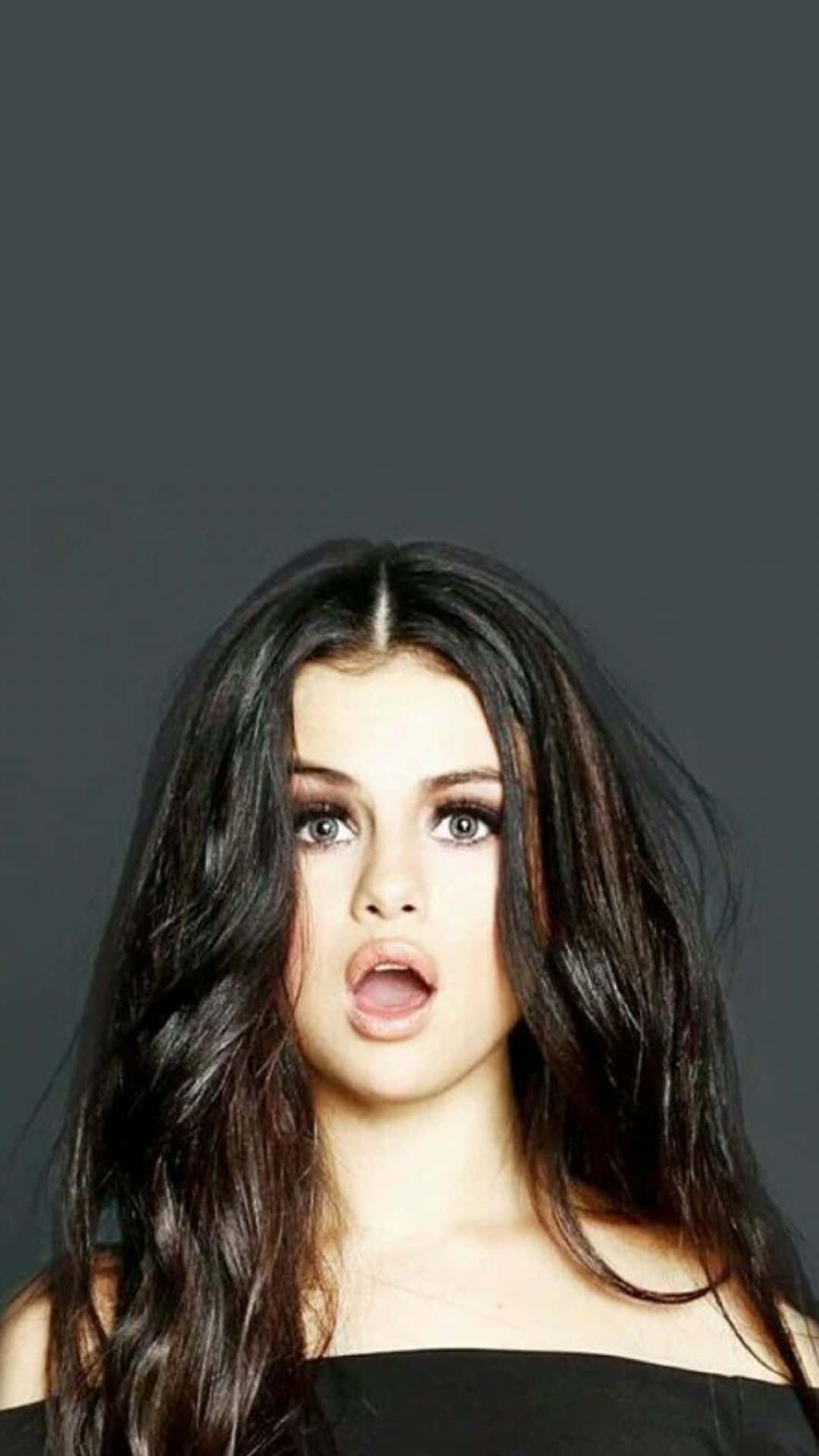 1080x1920 Download Selena Gomez holding her signature iPhone Wallpaper