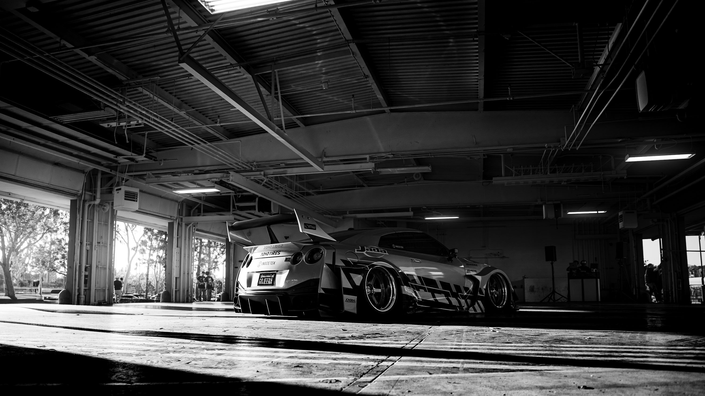 3000x1688 Sports car parked inside a dimly lit garage photo