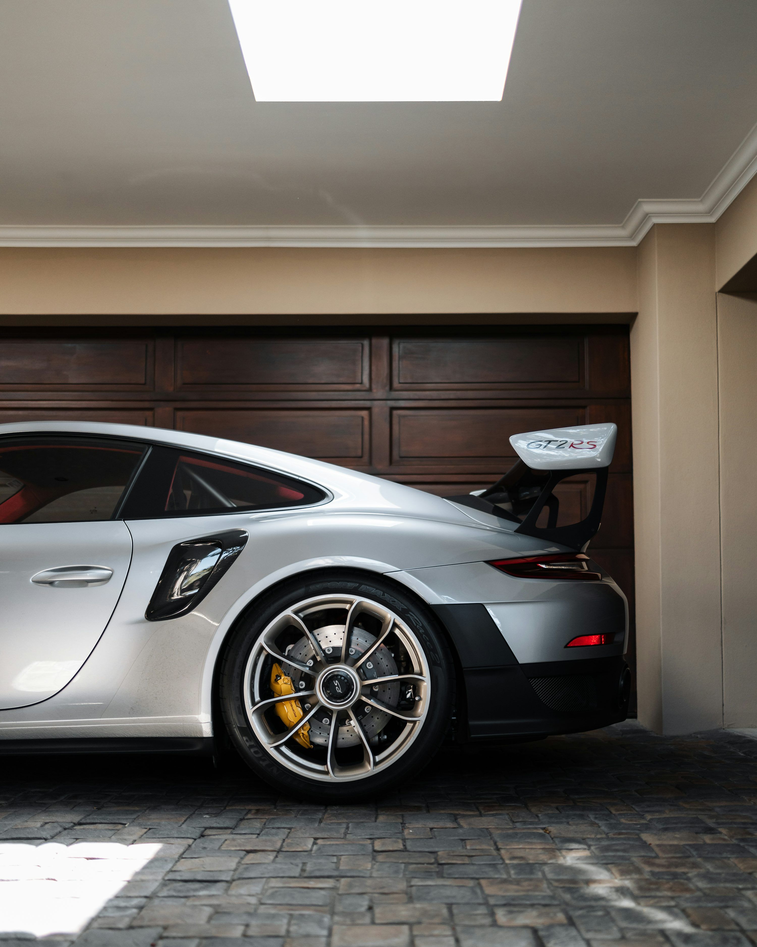 3000x3750 A silver sports car parked in a garage photo