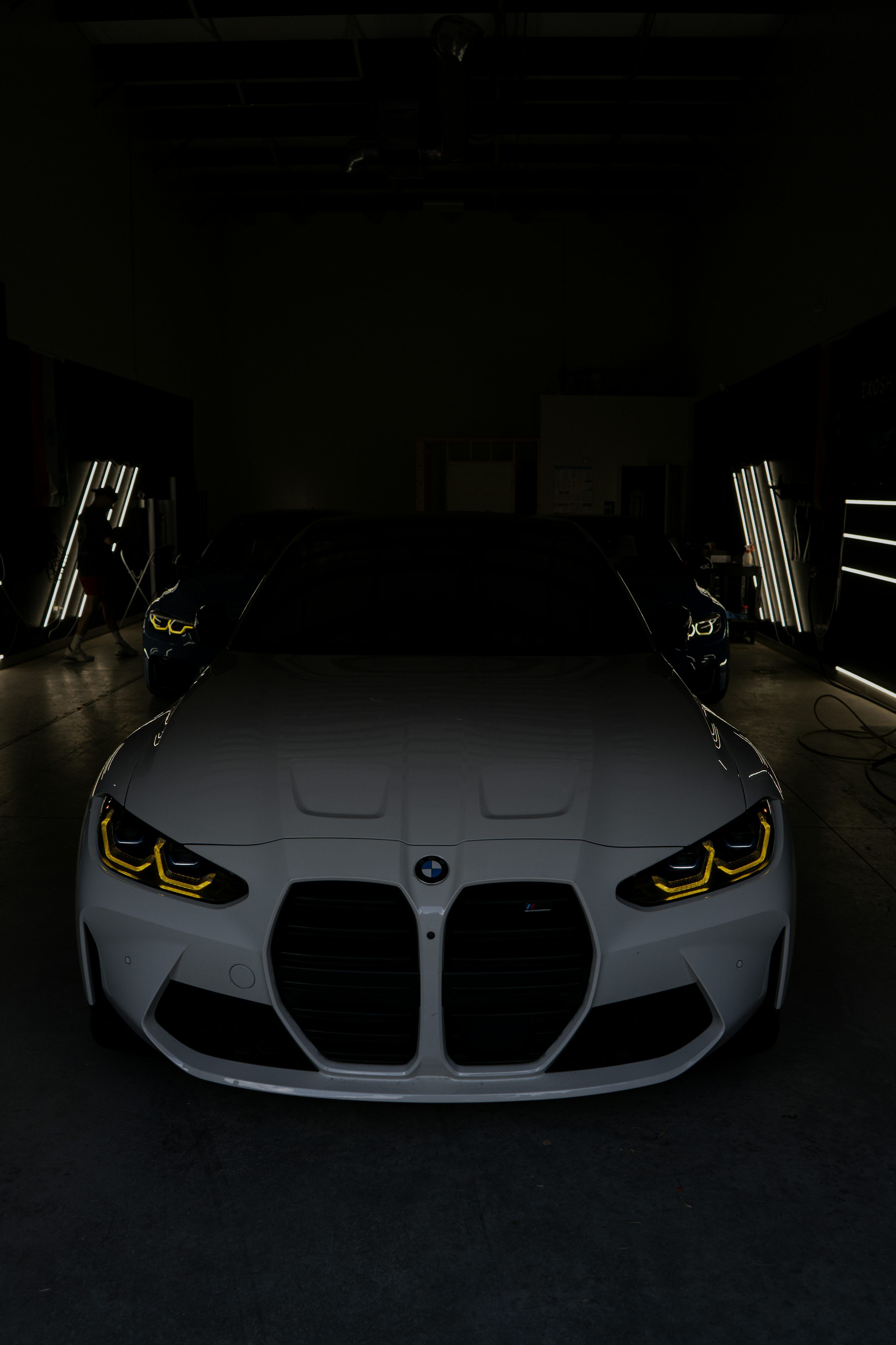 3000x4500 A white BMW car in a dark garage. photo