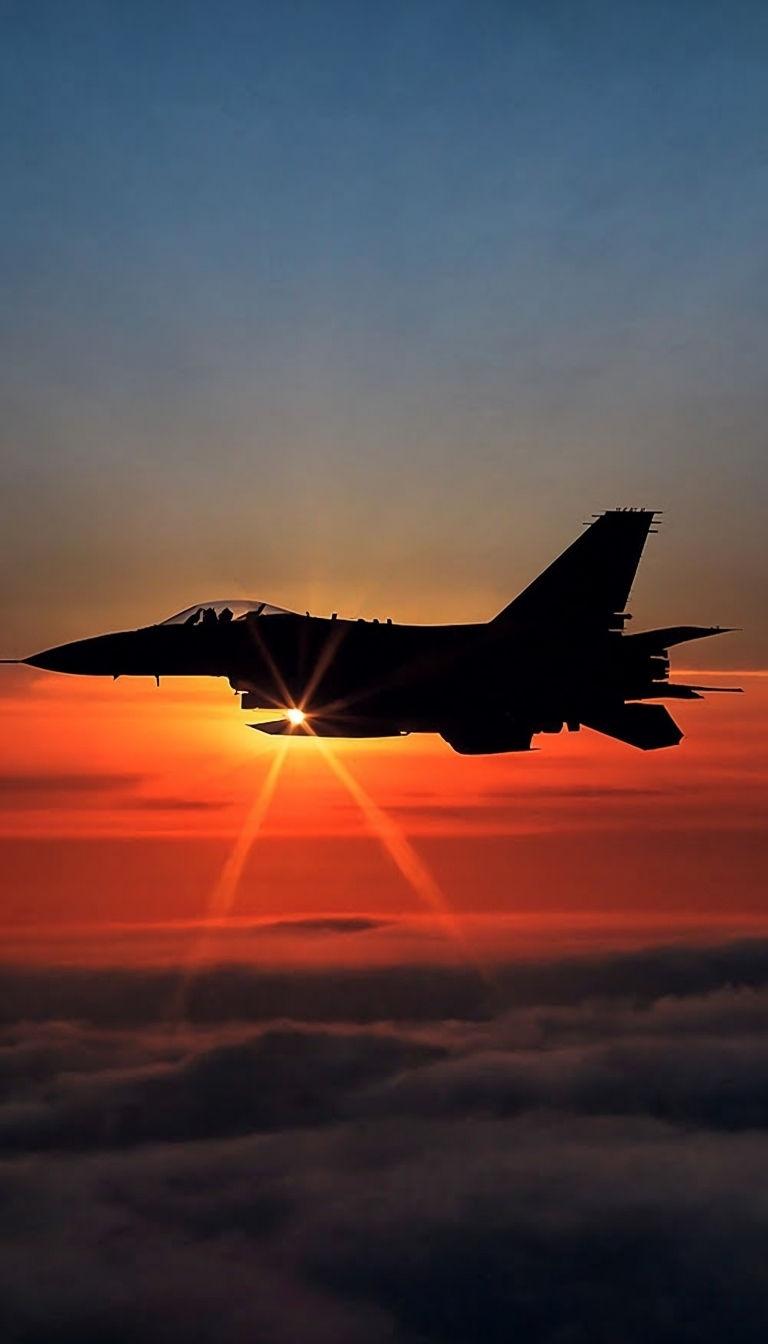 768x1344 Silhouetted F 16 Fighting Falcon Against Vibrant Sunset Sky Mobile Wallpaper