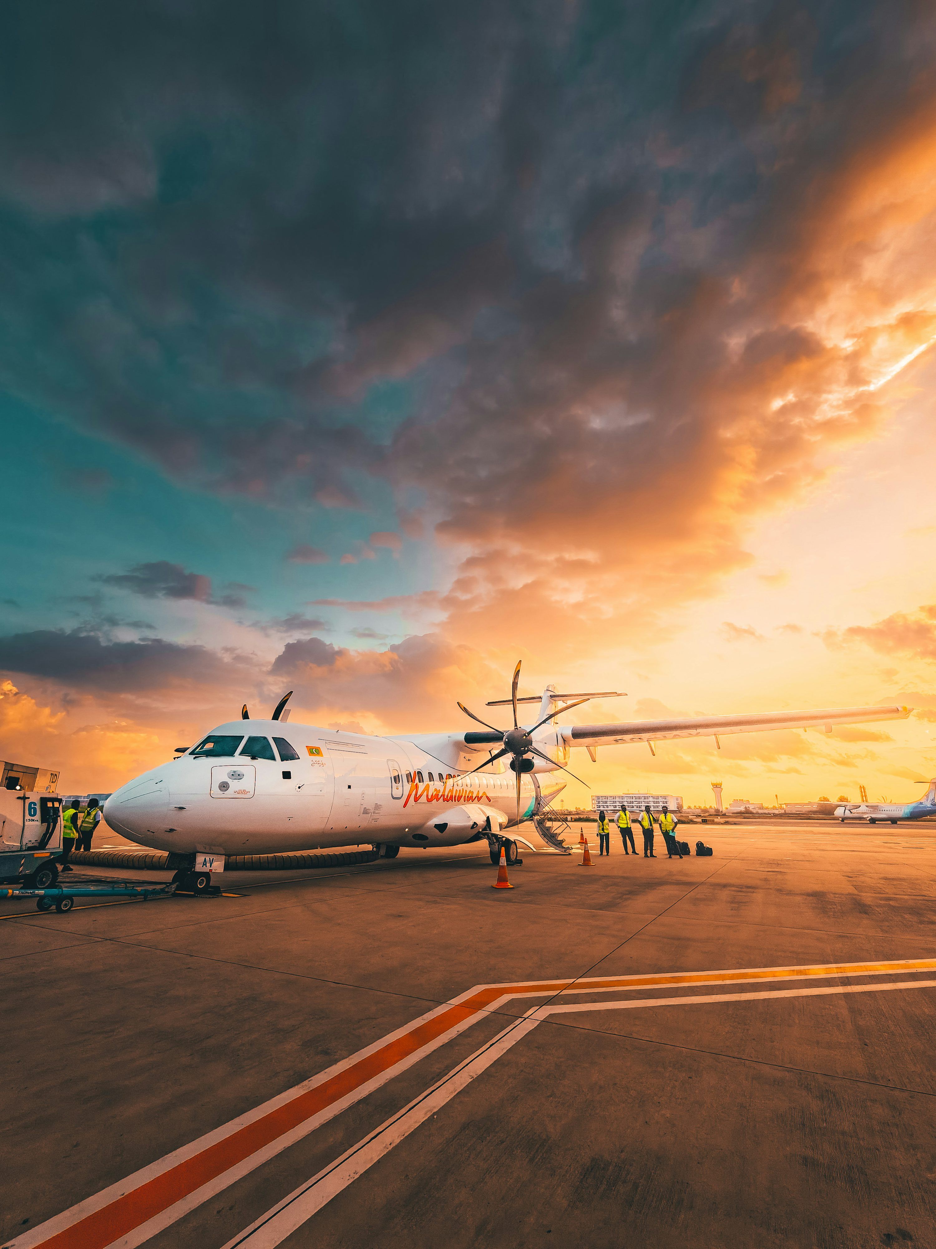 3000x4000 Airplane on tarmac at sunset with dramatic clouds photo
