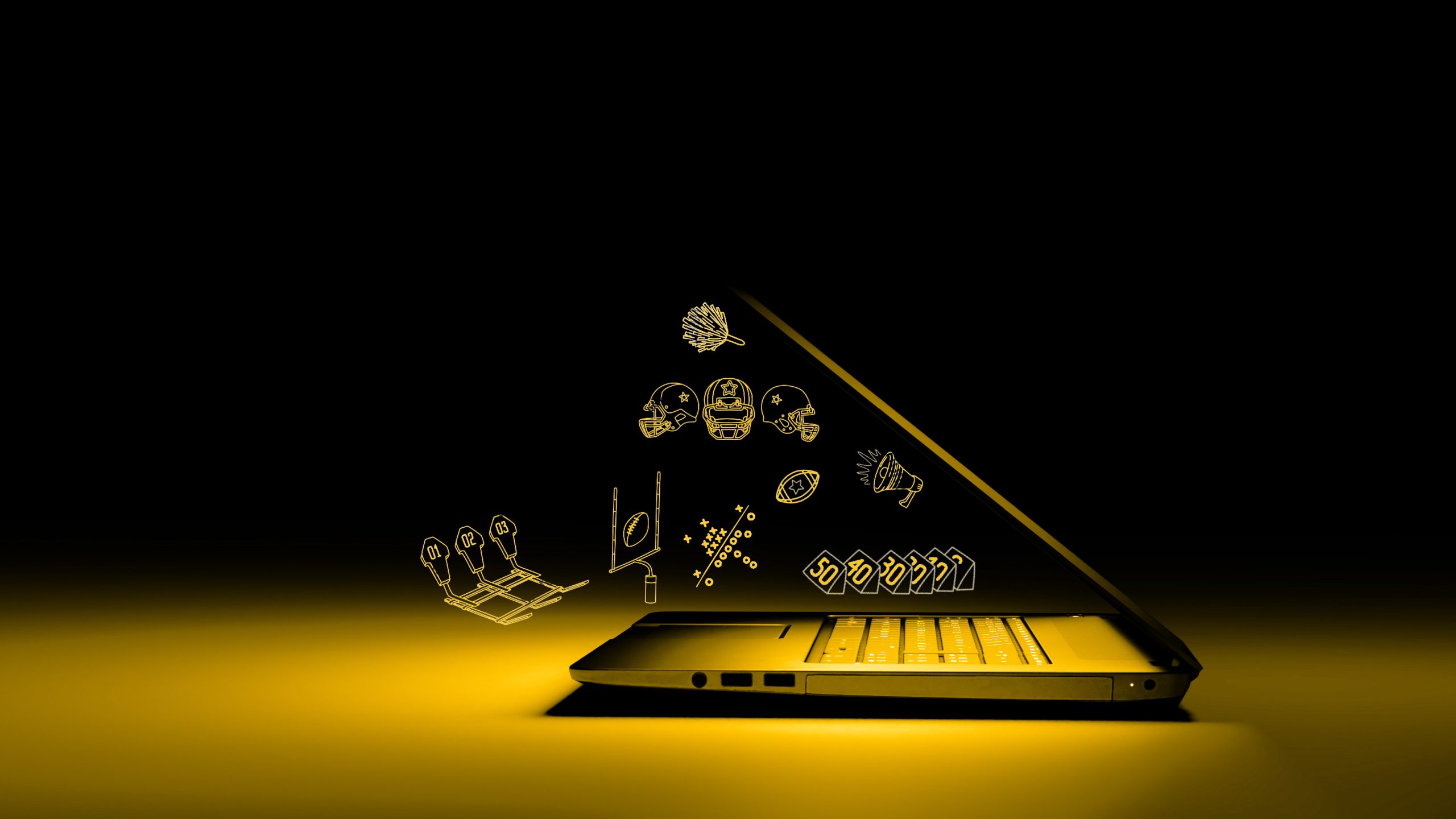 2560x1440 Side view of laptop PC with color light on dark background. Tech