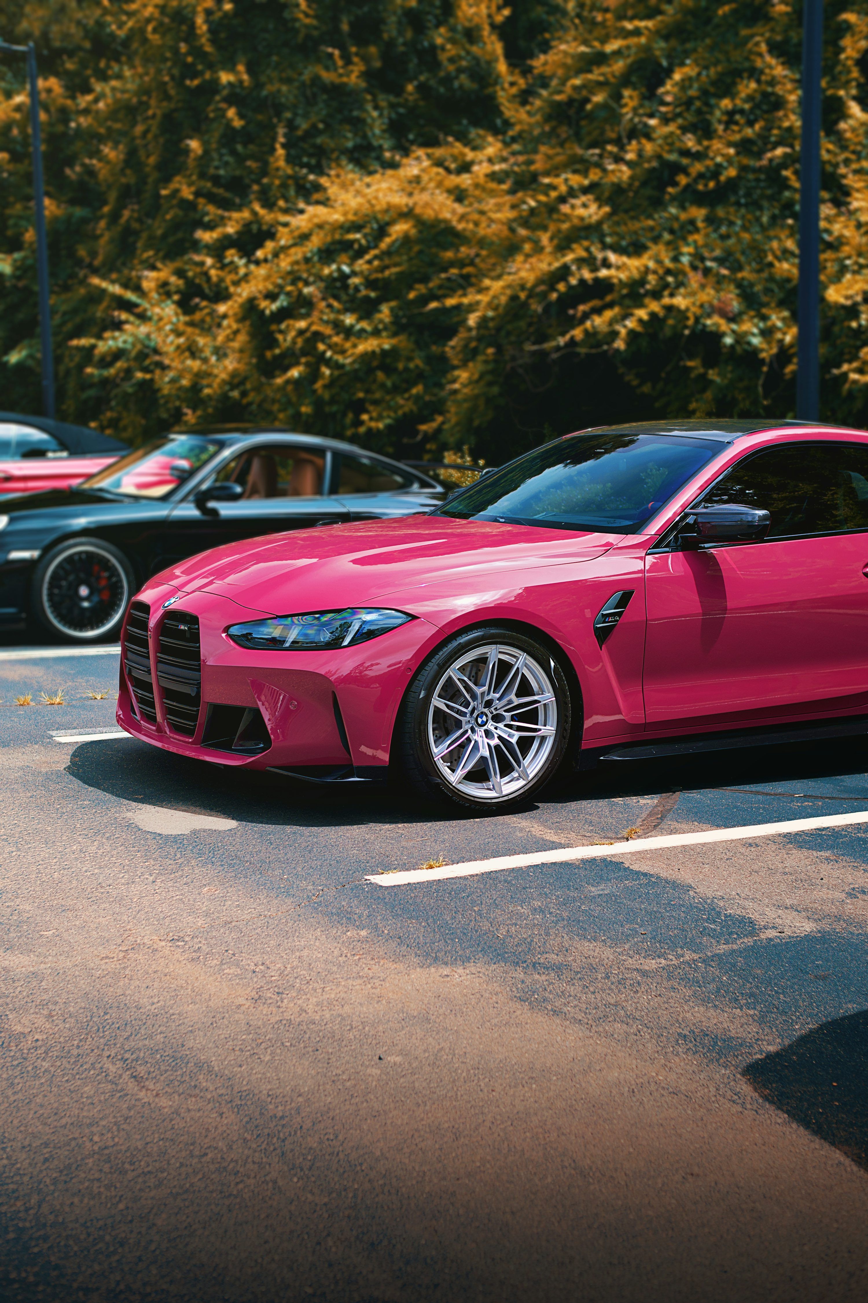 3000x4500 A pink BMW m4 sits parked. photo
