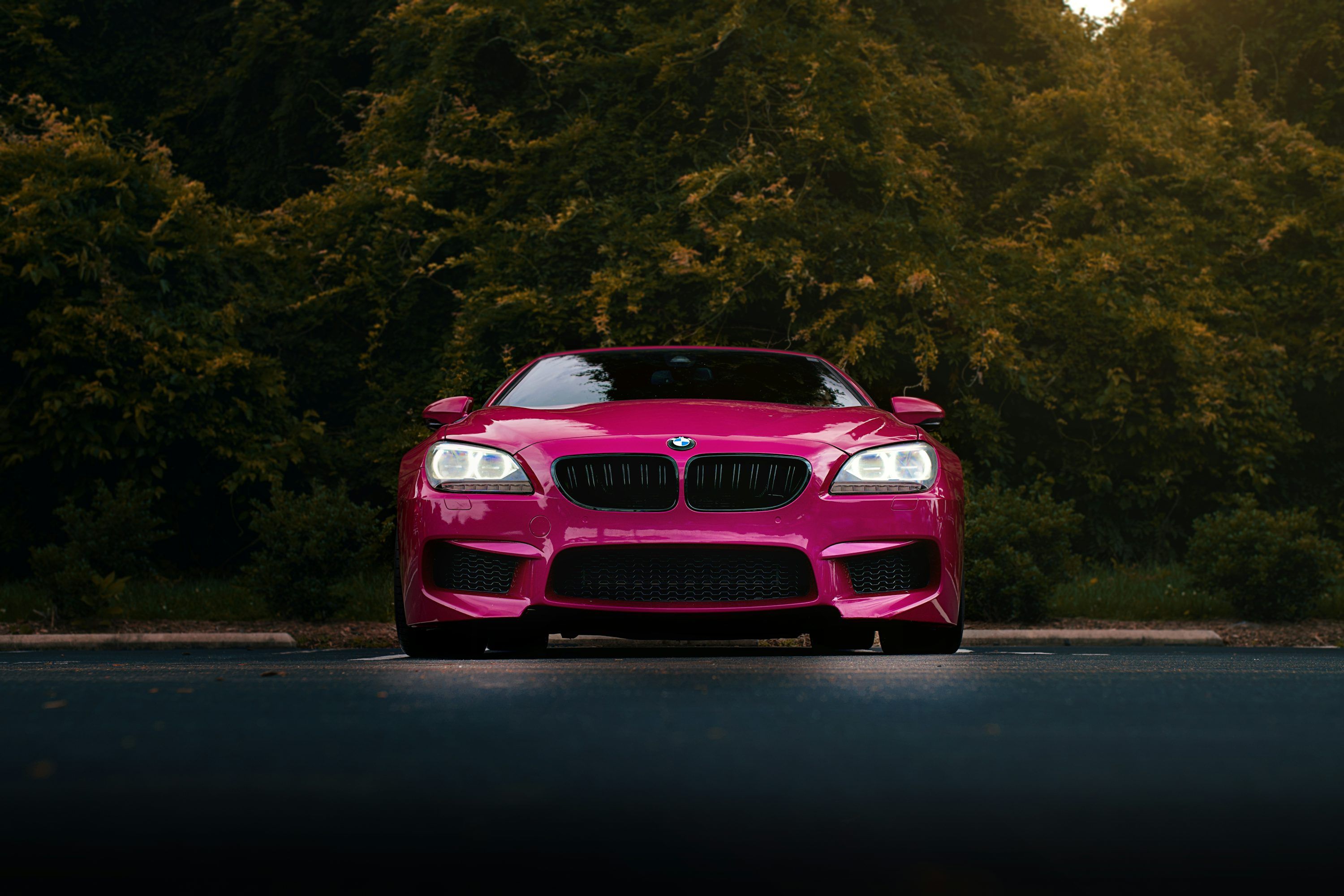 3000x2000 A pink BMW car is parked outside. photo