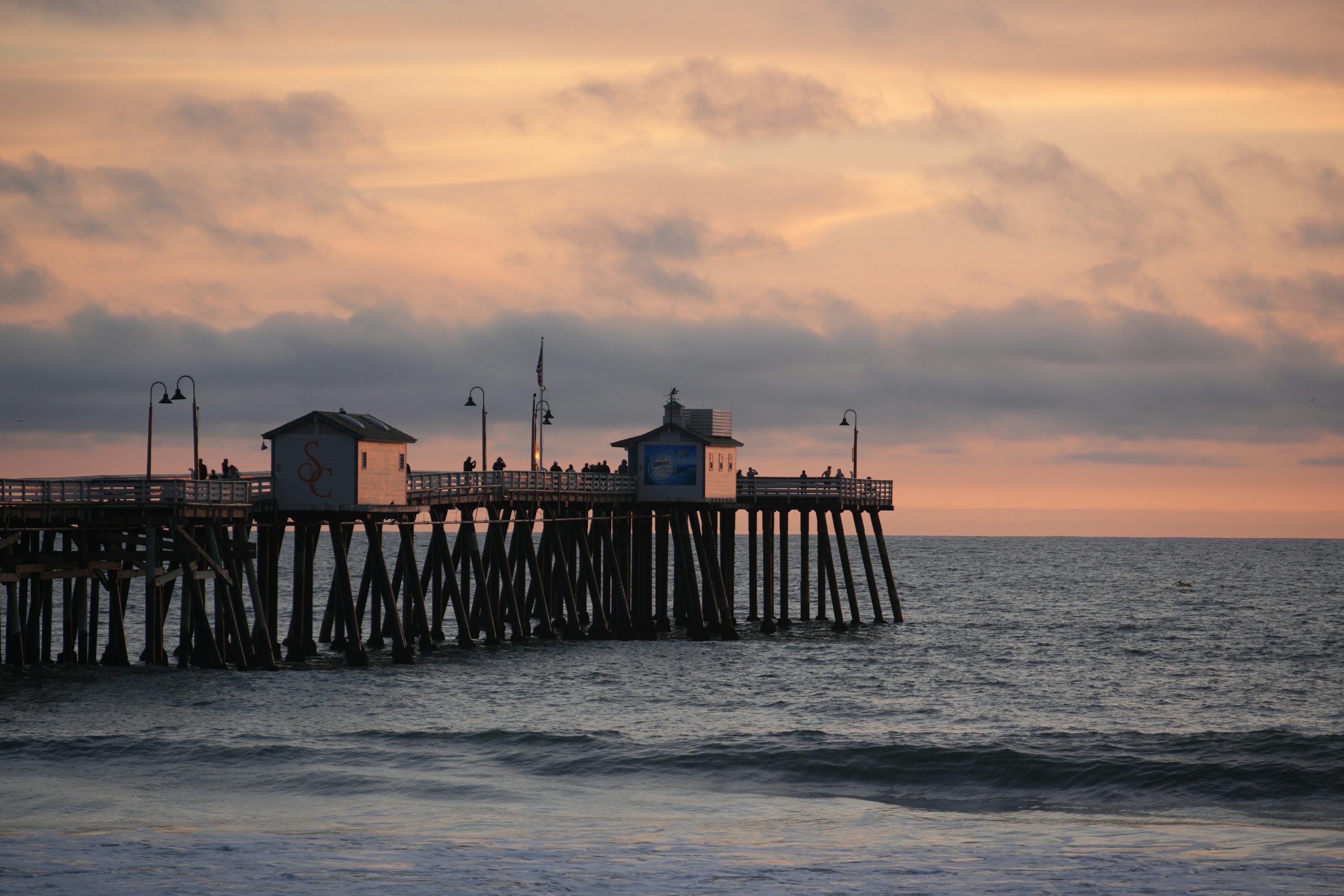 3000x2000 A pier on the ocean with a sky background photo