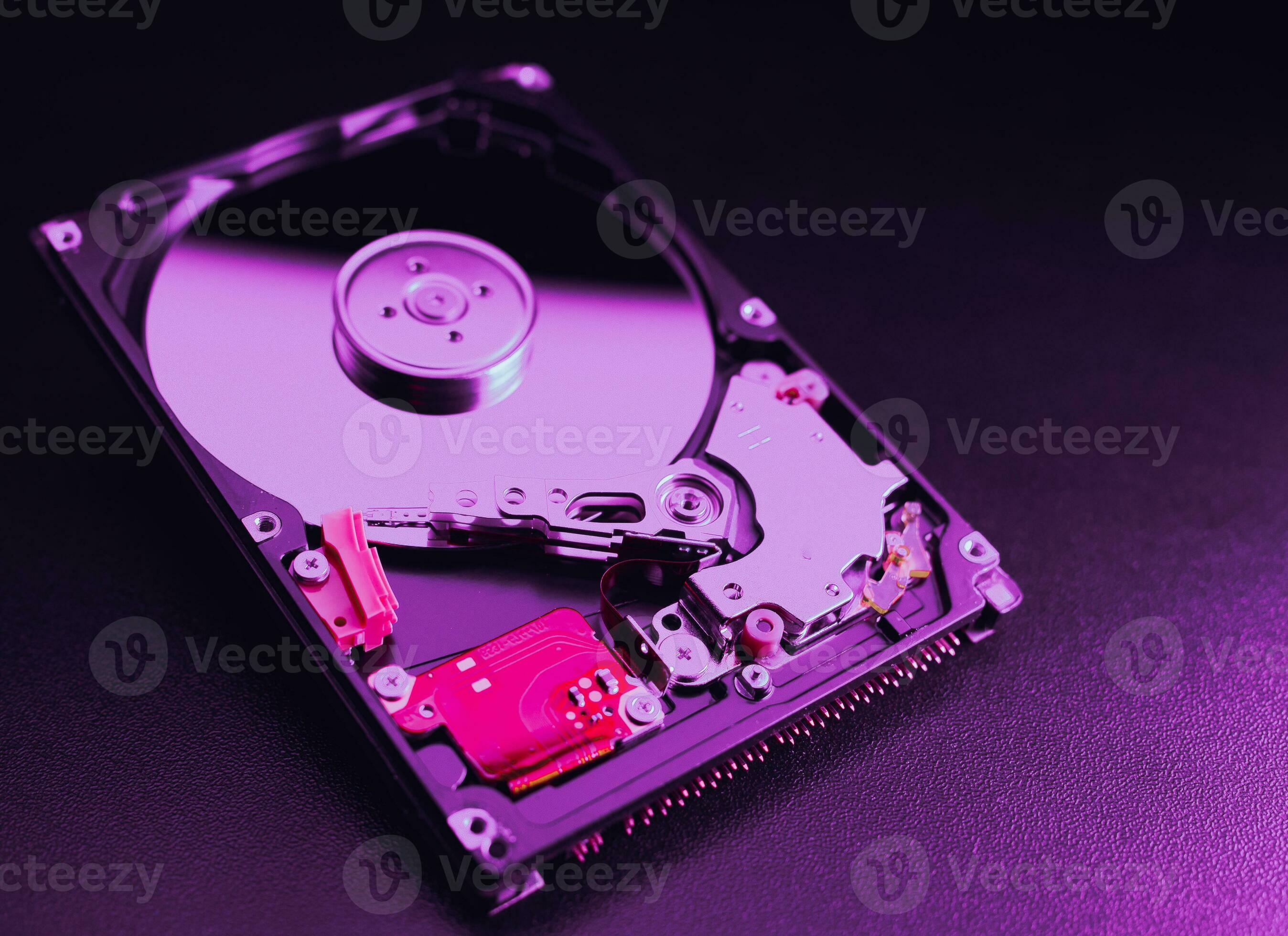 2696x1960 An open hard disk disassembled HDD of a computer or laptop lies on a purple surface. Computer hardware and accessories. Hard disk storage