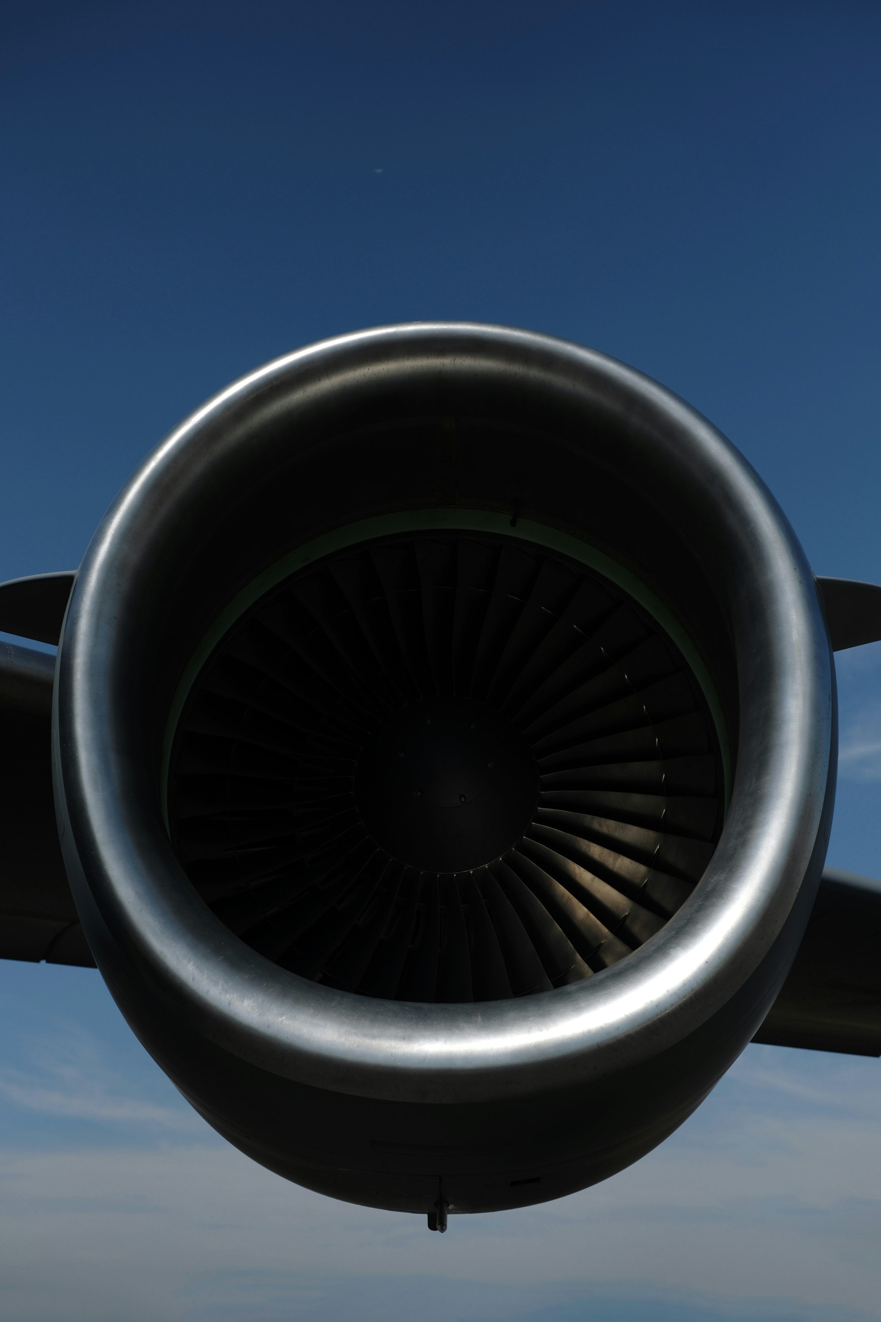 3000x4500 Close up of a jet engine against blue sky photo