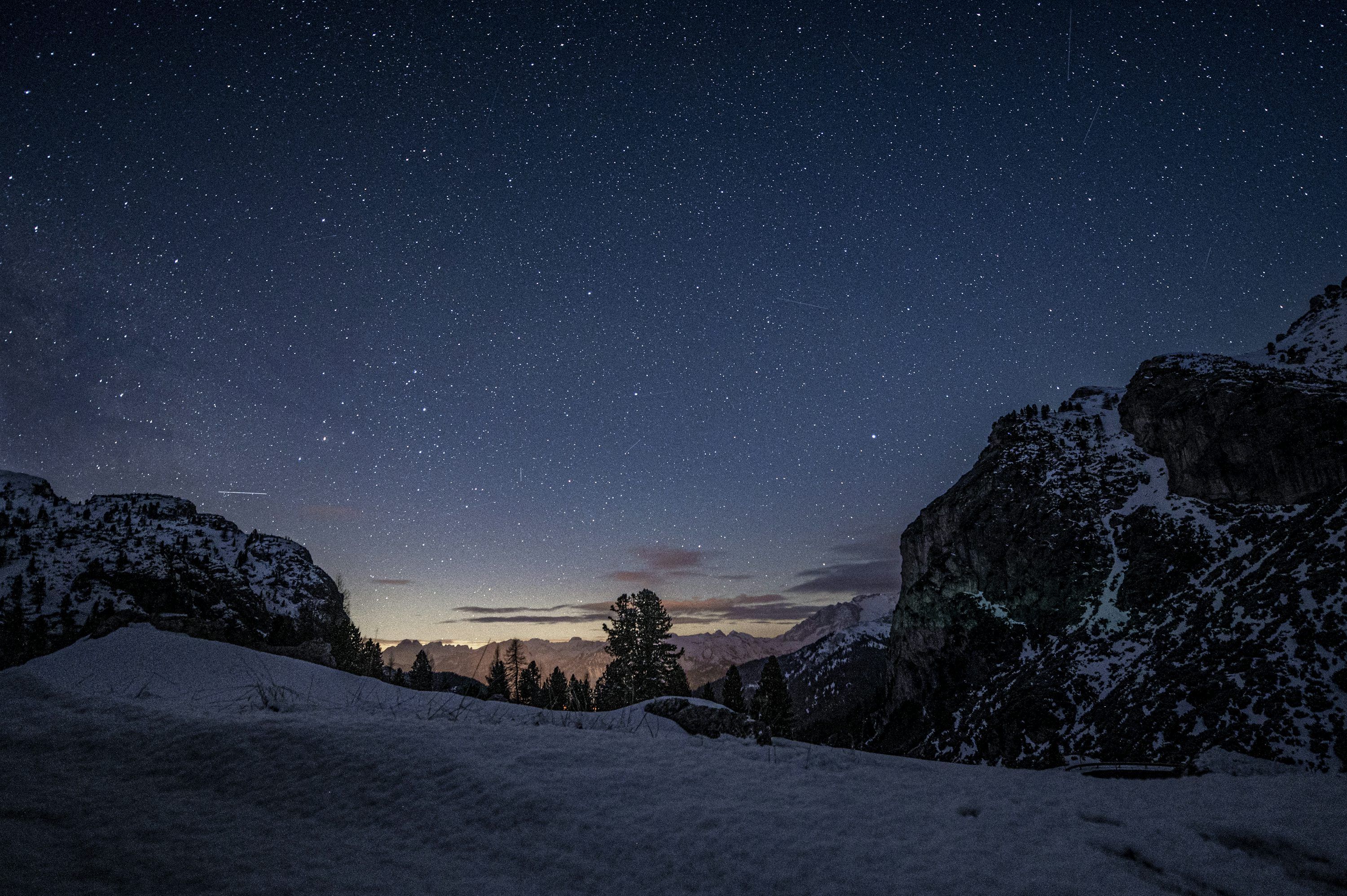 3000x1996 A night sky with stars above a snowy mountain photo