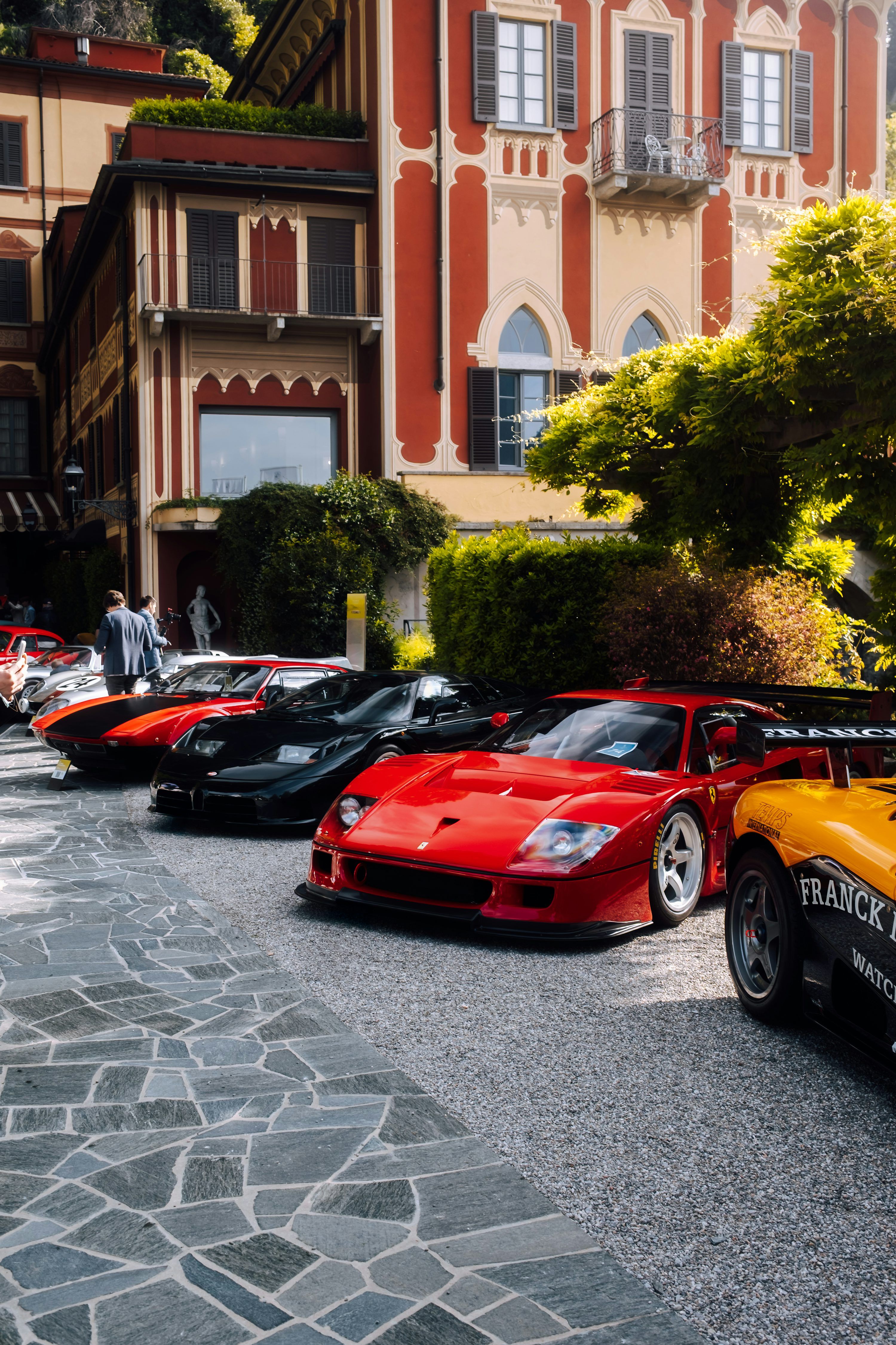 3000x4501 Luxury cars are parked in front of an elegant building. photo