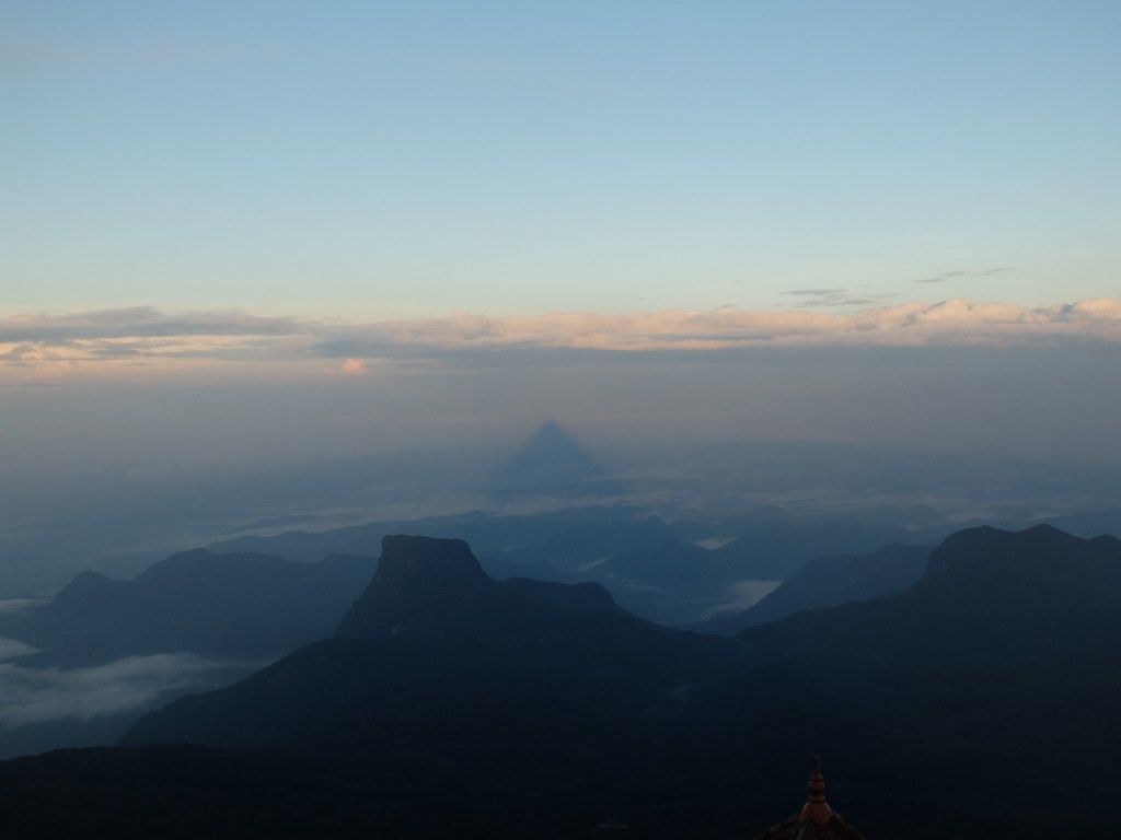 1024x768 Sri Pada's (Adam's Peak) triangular shadow in the clouds a