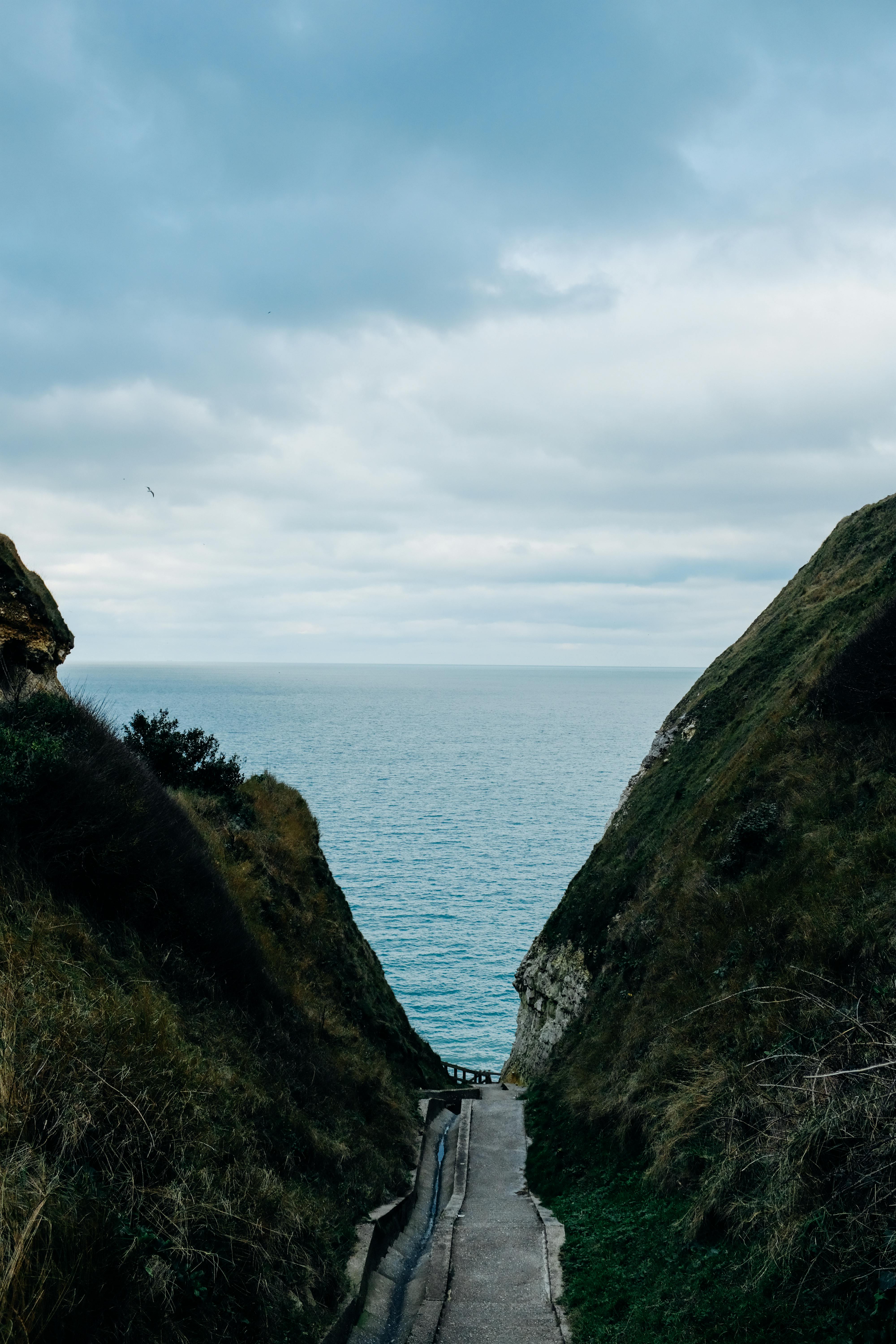4000x6000 Narrow path surrounded with green rocky cliffs · Free
