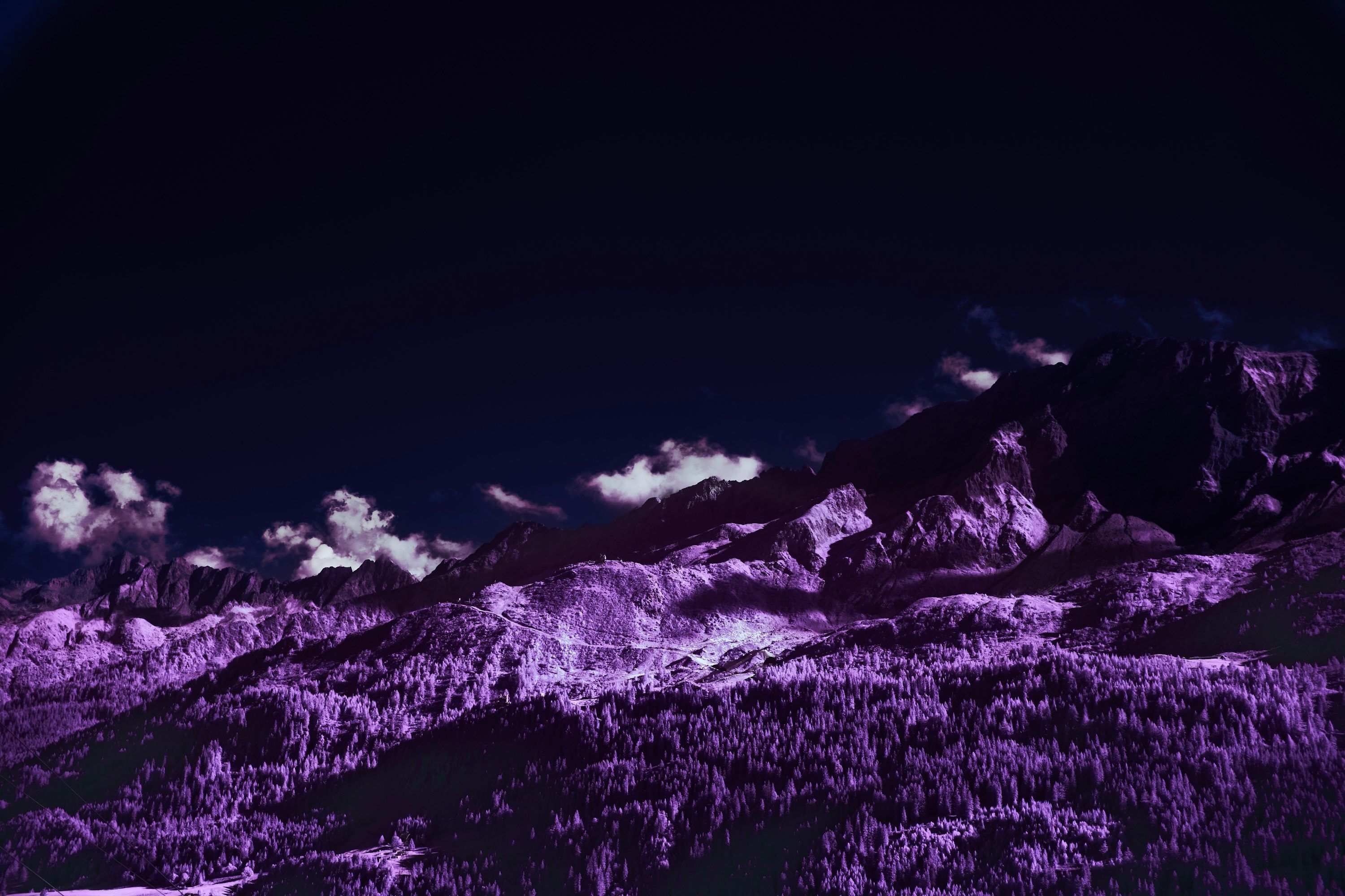 3000x2000 A purple picture of a mountain range under a dark sky photo