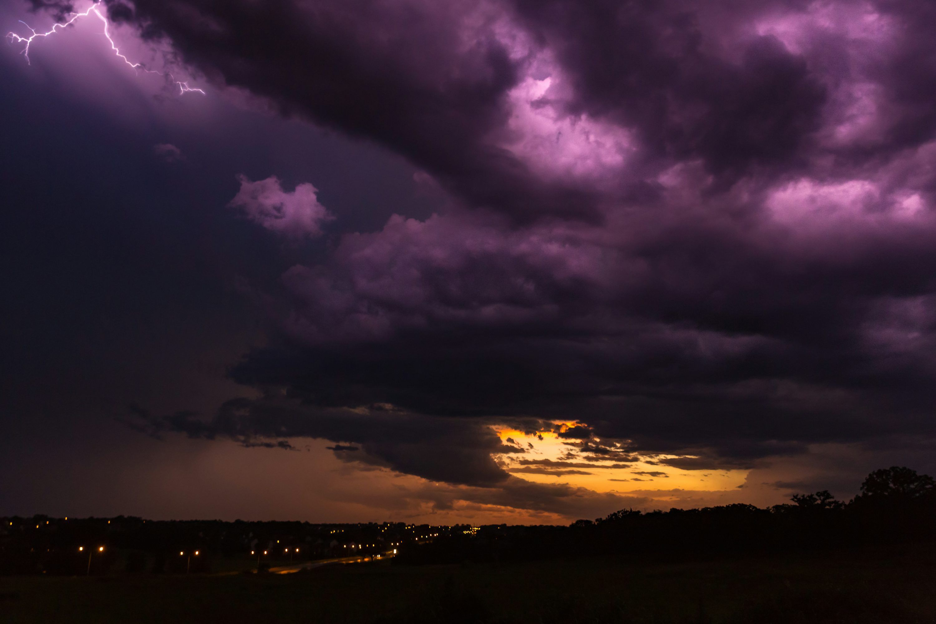 3000x2000 City at night under purple and orange cloudy sky photo