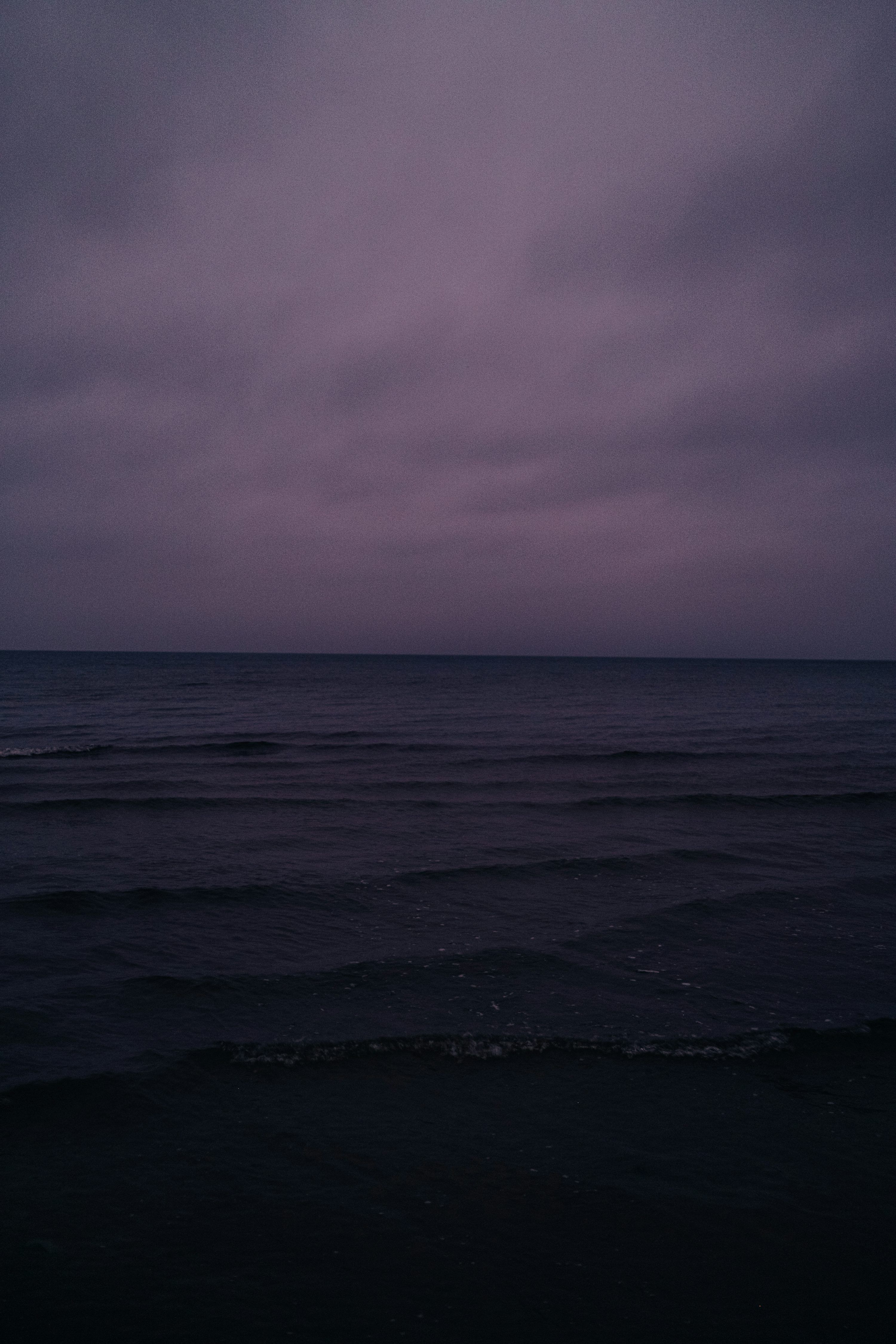 3000x4500 Purple sky over a dark, calm ocean. photo
