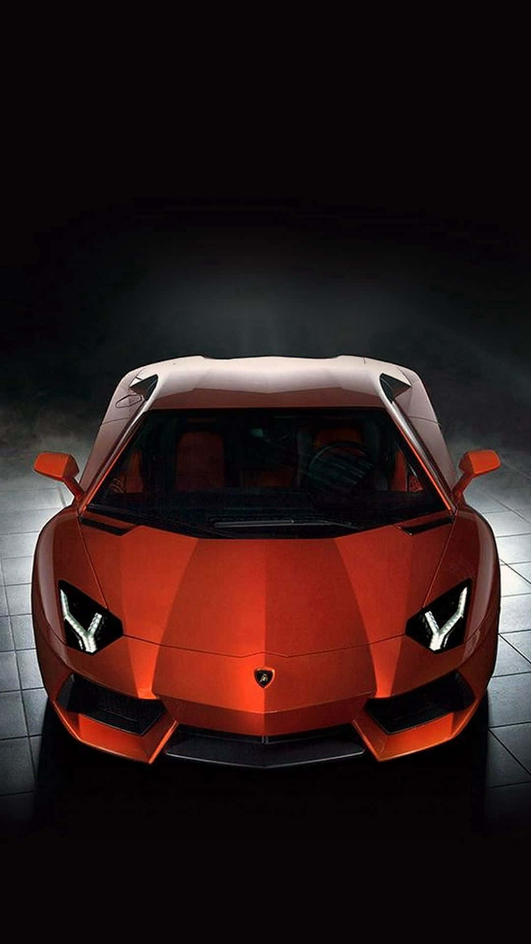 1080x1920 Download A Red Sports Car Is Shown In A Dark Room Wallpaper