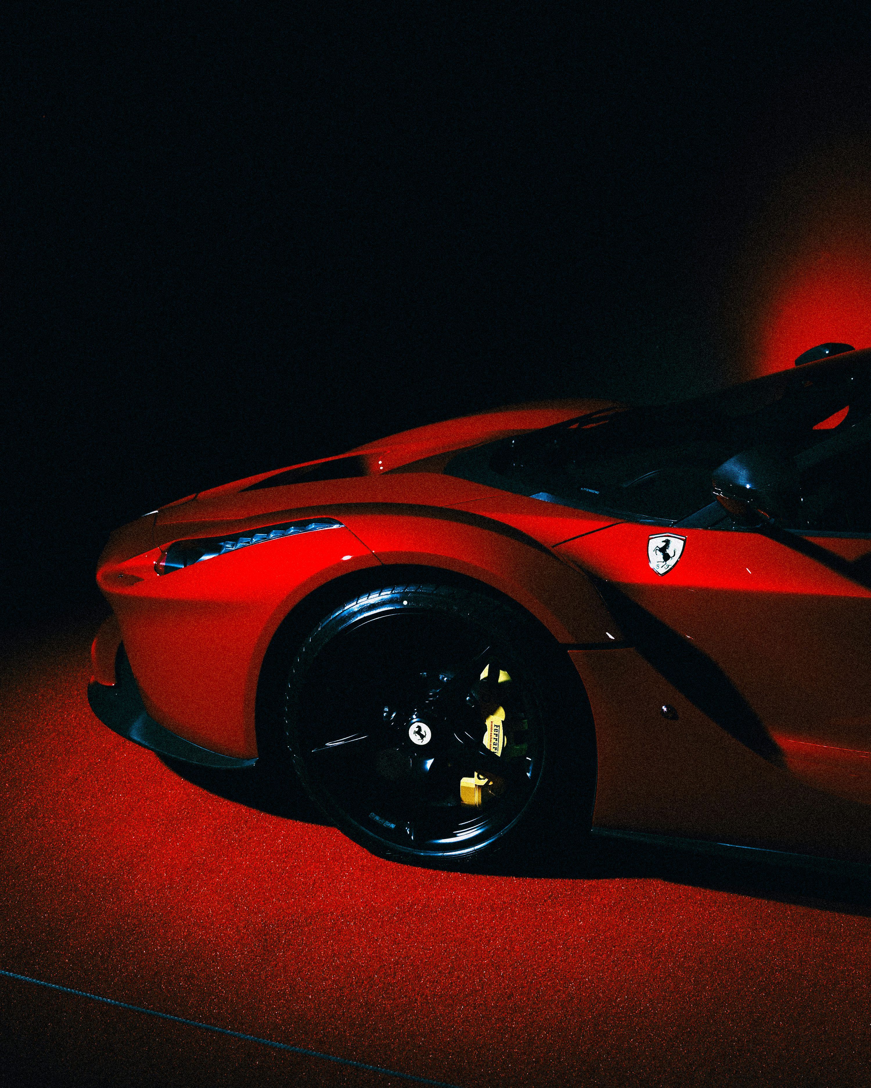 3000x3750 A sleek, red ferrari shines in the darkness. photo