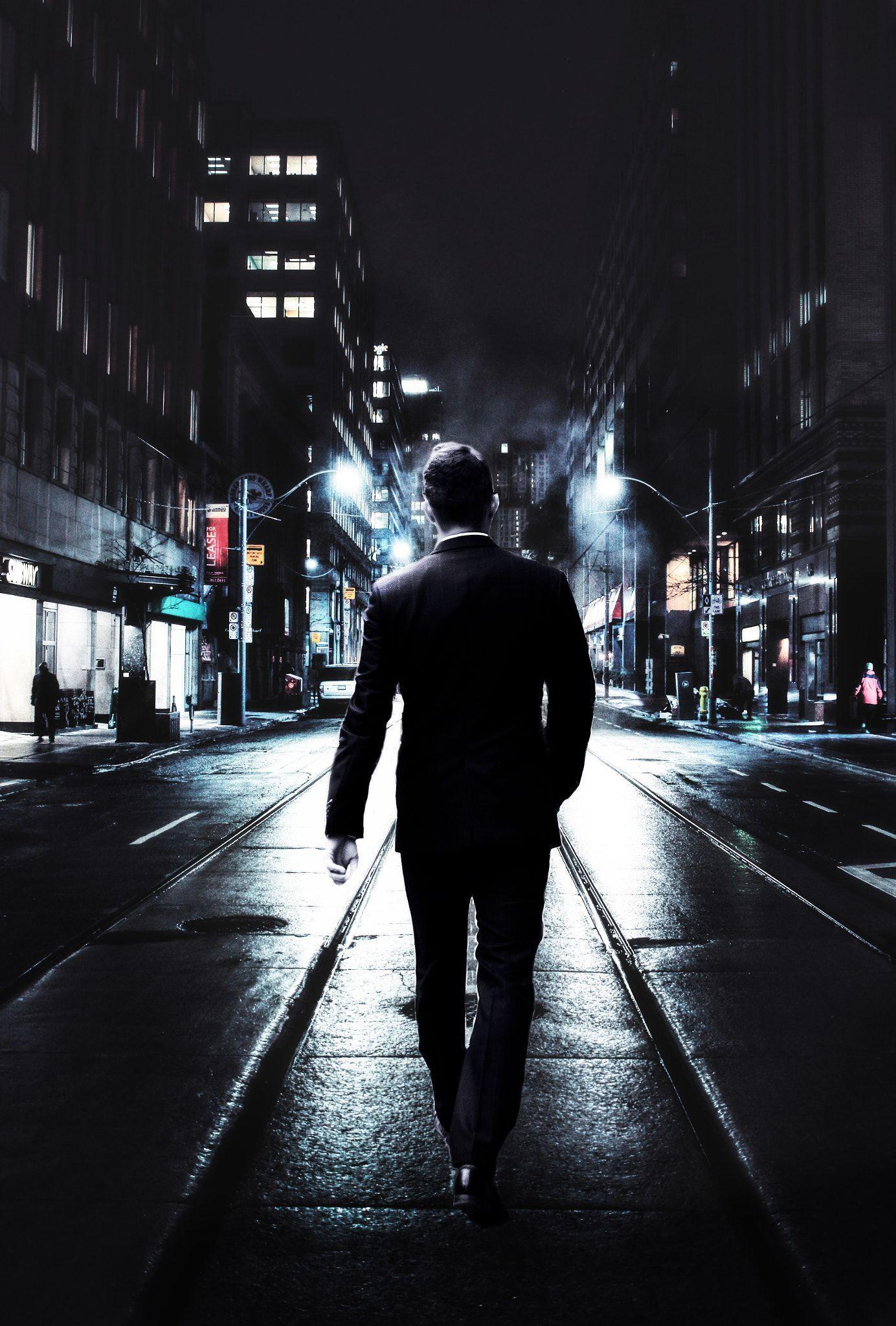 1384x2048 Young man wearing business suit walking down the street at night