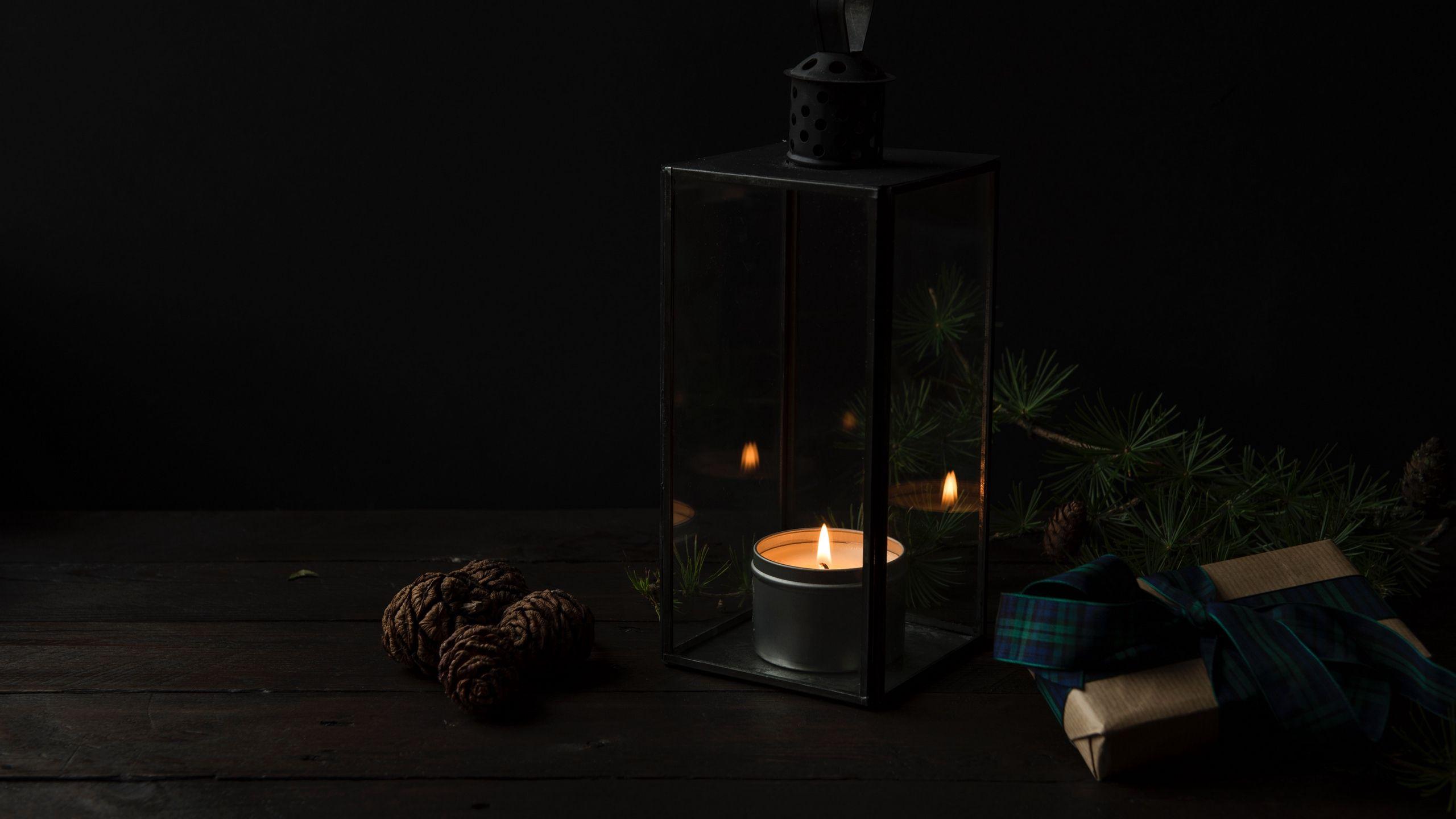 2560x1440 Download wallpaper 2560x1440 candlestick, candle, gifts, dark