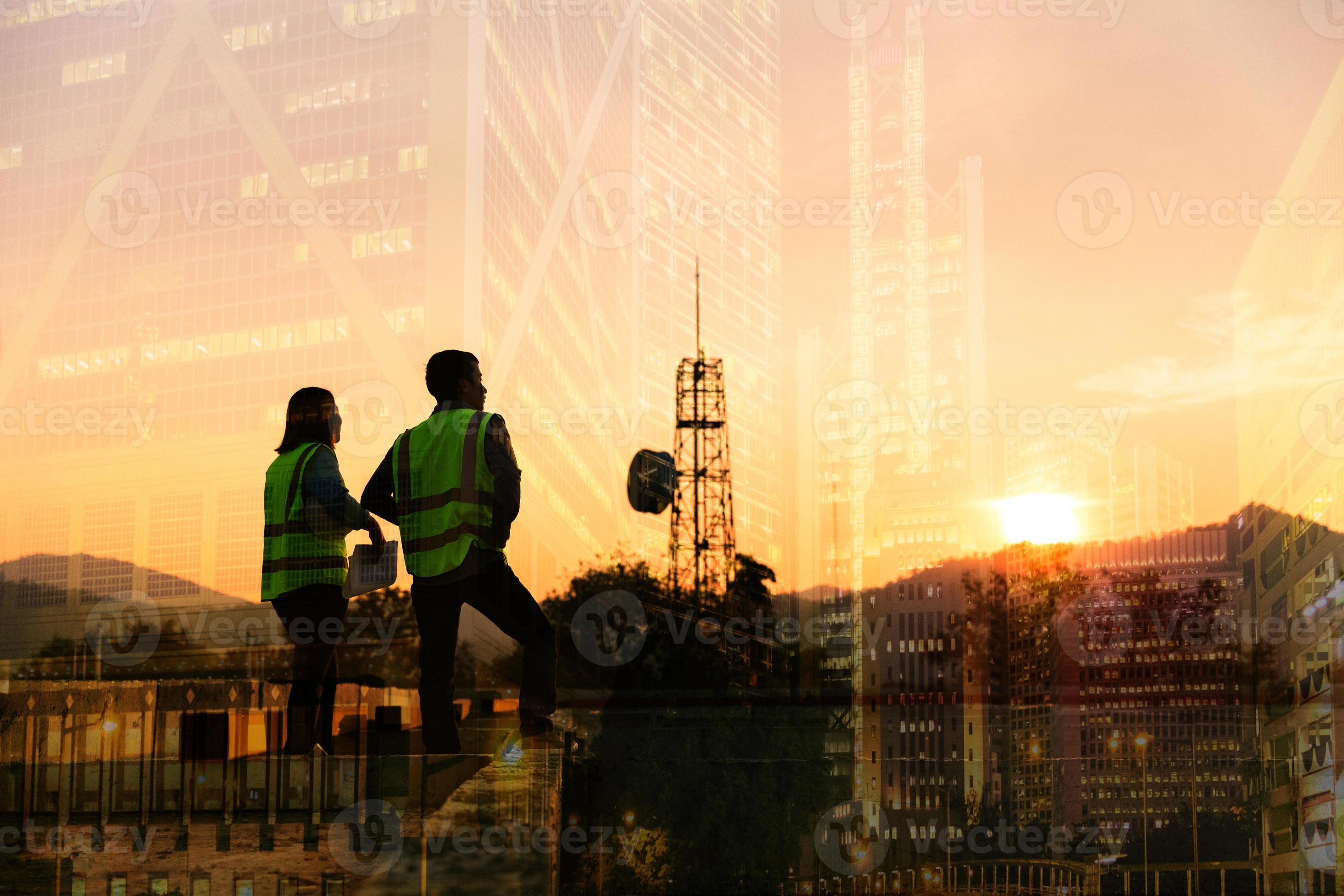 2940x1960 Double exposure image of engineer civil and construction worker with safety helmet and construction drawing against the background of surreal construction site in the night city or dark cityscape. 18903271