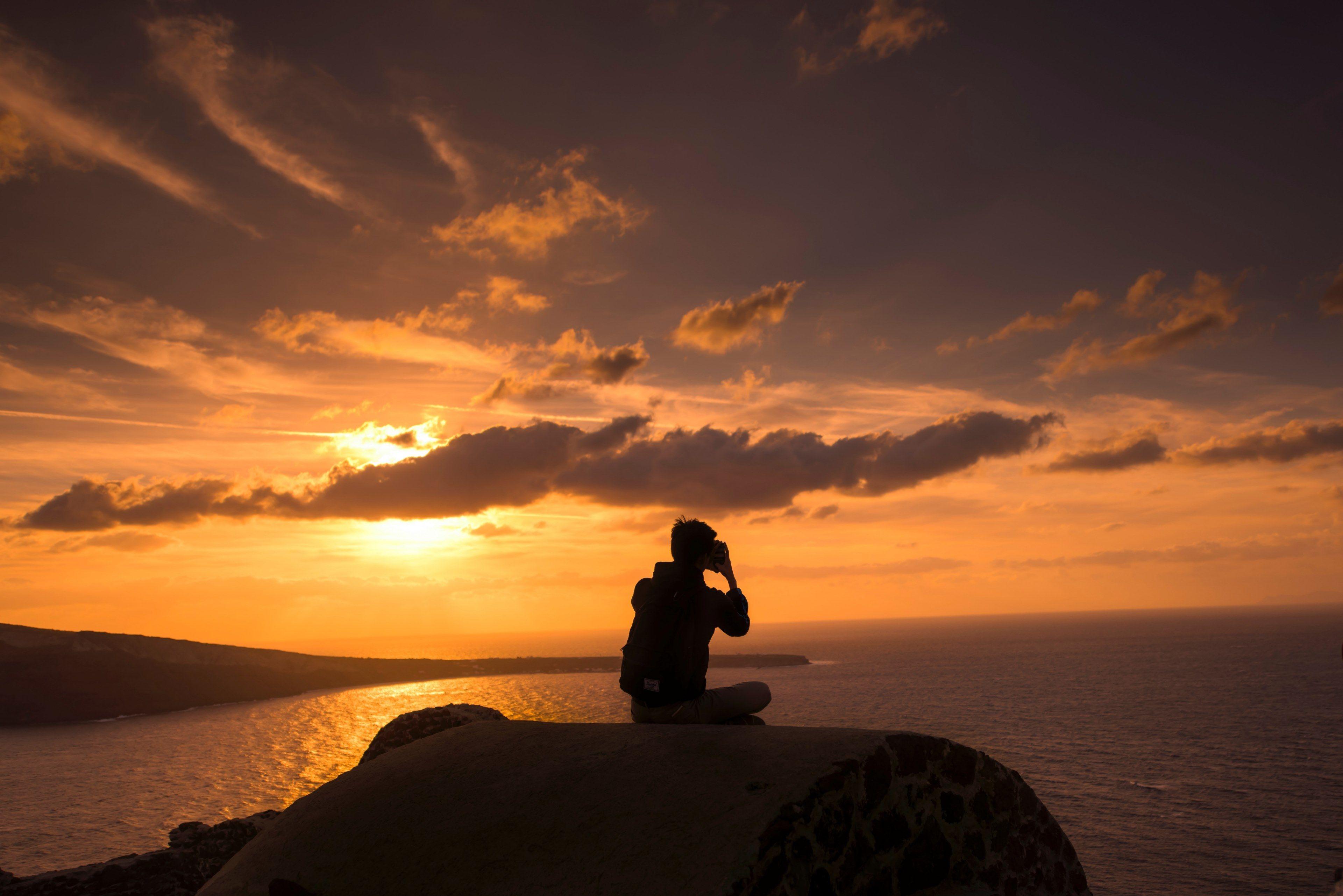 3840x2563 traveler takes picture sunset in santorini greece 4k wallpaper