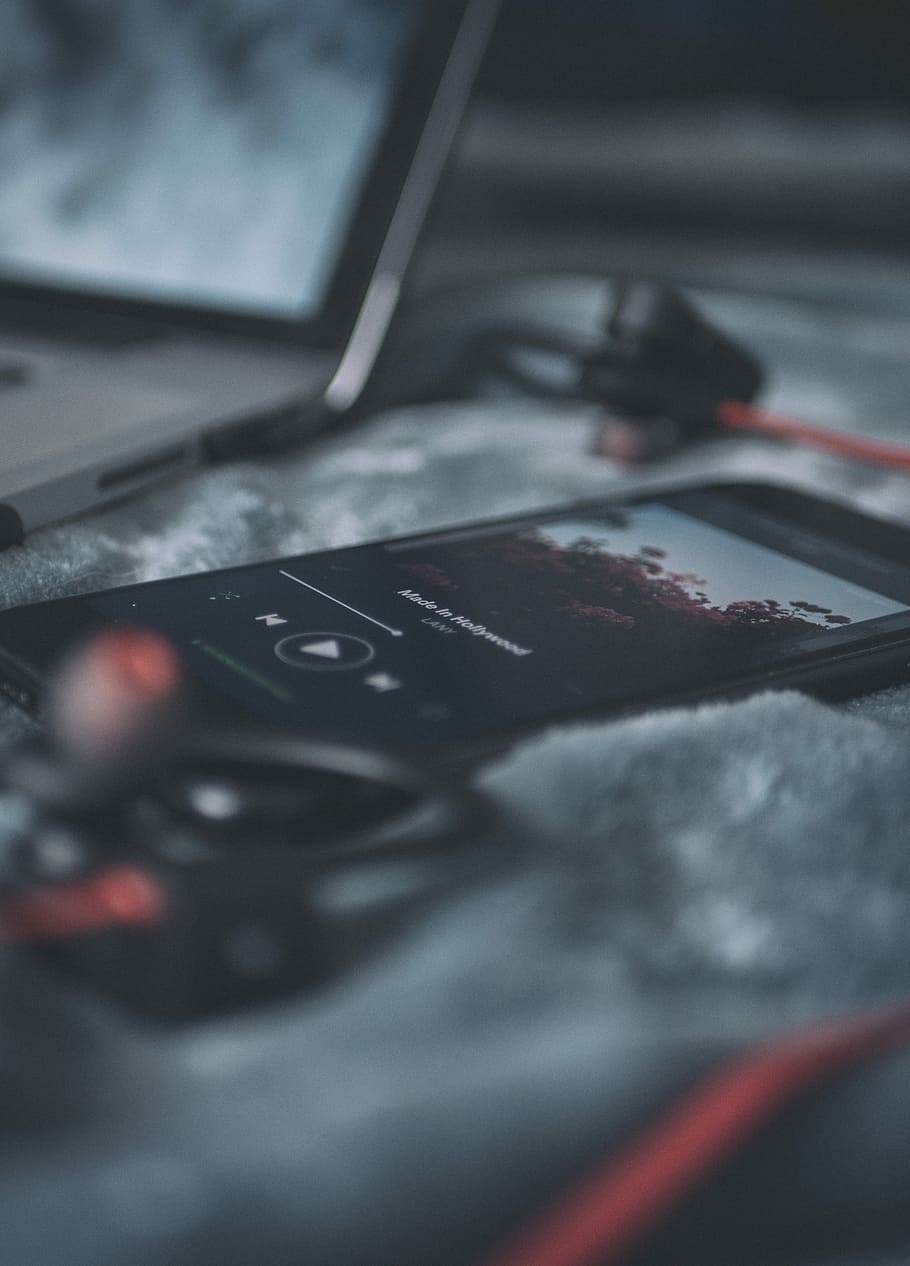 910x1266 HD wallpaper: black smartphone on gray textile, black phone beside