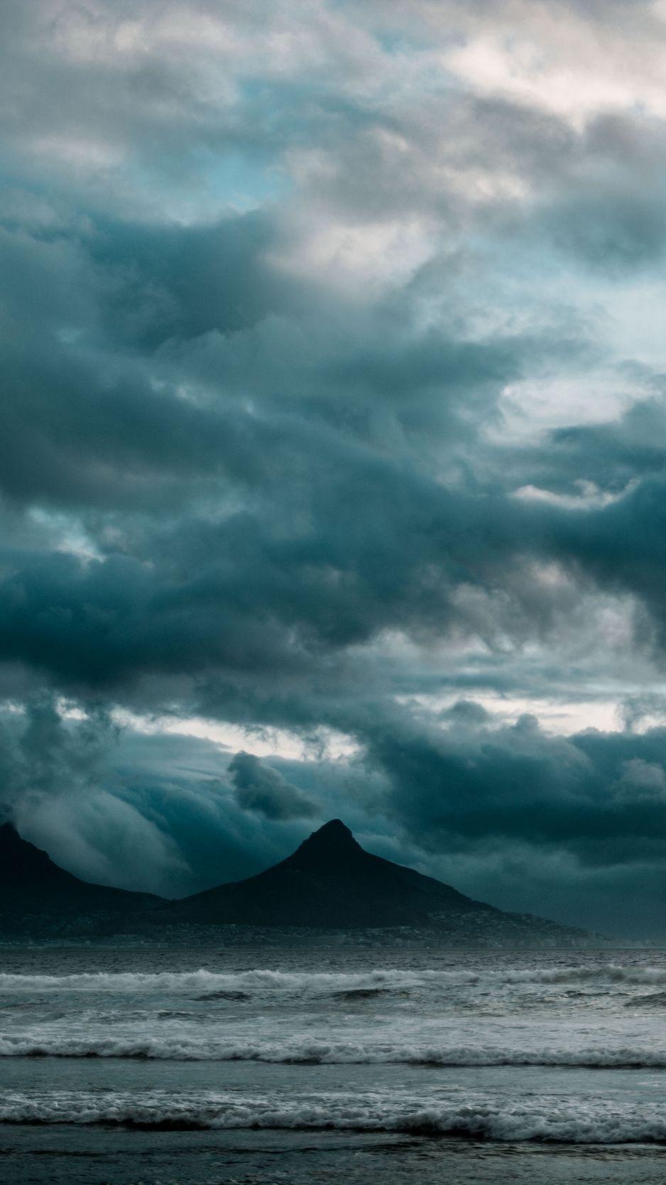 938x1668 Download wallpaper 938x1668 ocean, surf, rocks, clouds, overcast