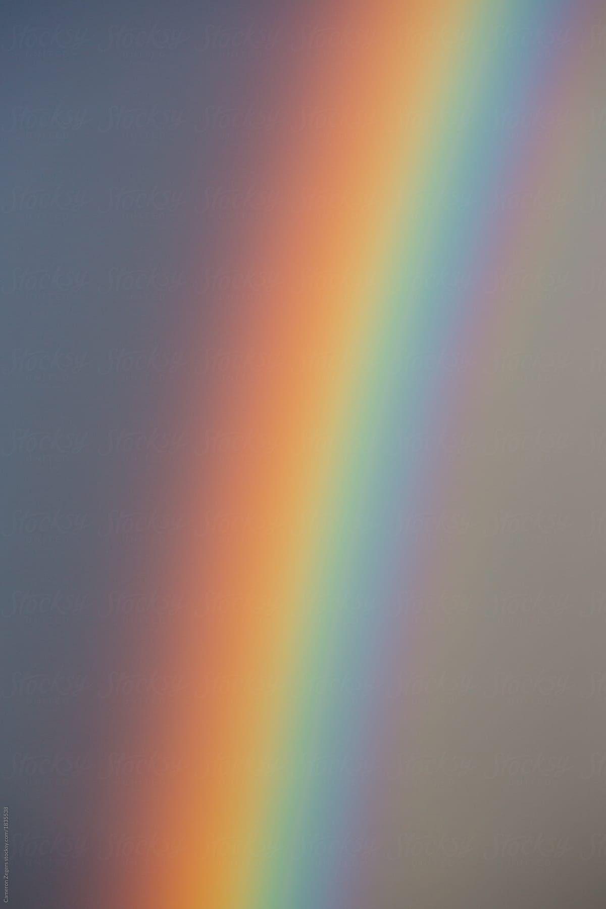 1200x1799 closeup of rainbow and sky by Cameron Zegers for Stocksy United