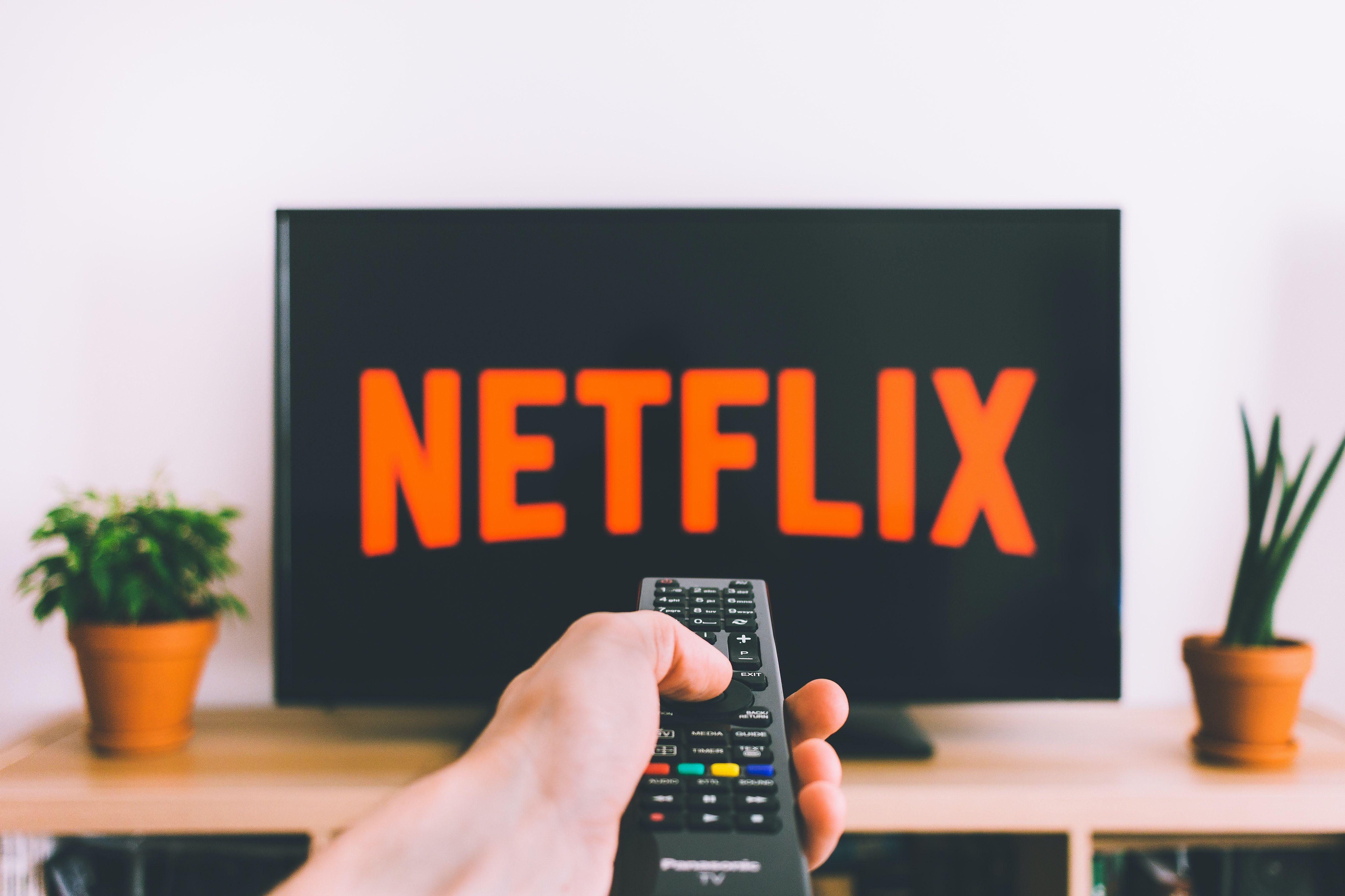 5133x3422 Closeup Photo of Person Holding Panasonic Remote Control in Front