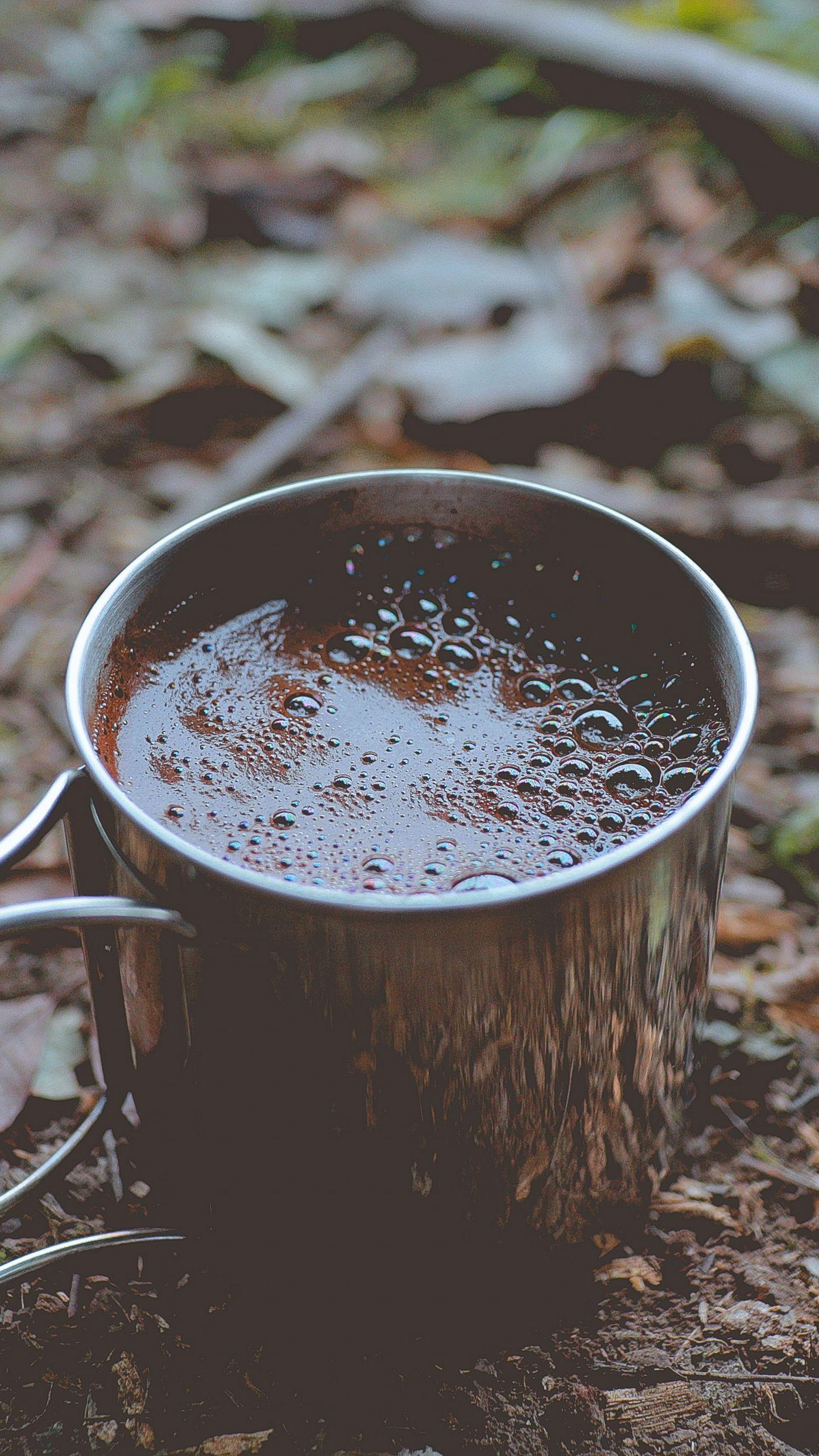 1440x2560 Download wallpaper 1440x2560 coffee, mug, foam, foliage qhd