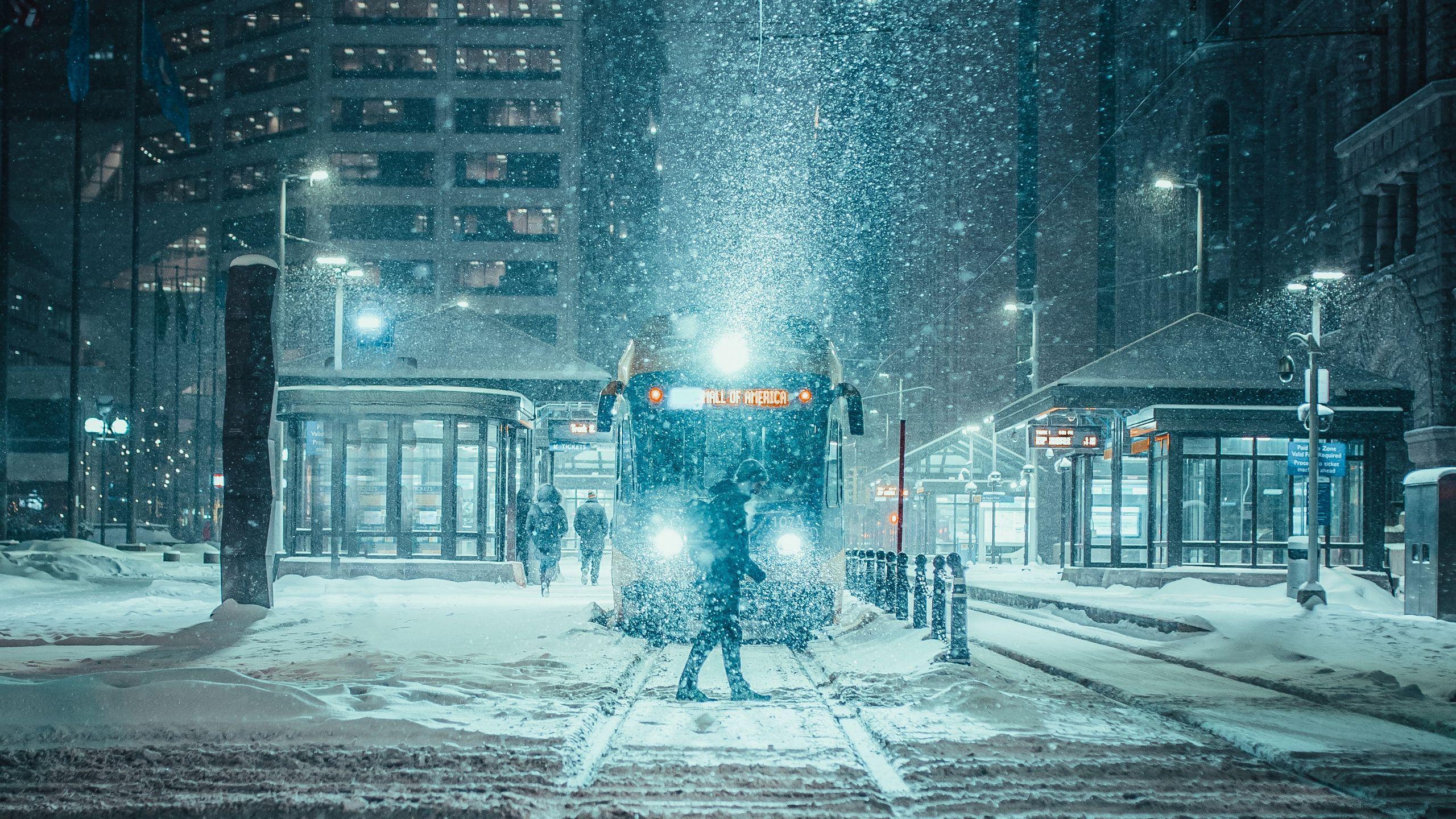 2560x1440 Download wallpaper 2560x1440 snowfall, night, city, transport
