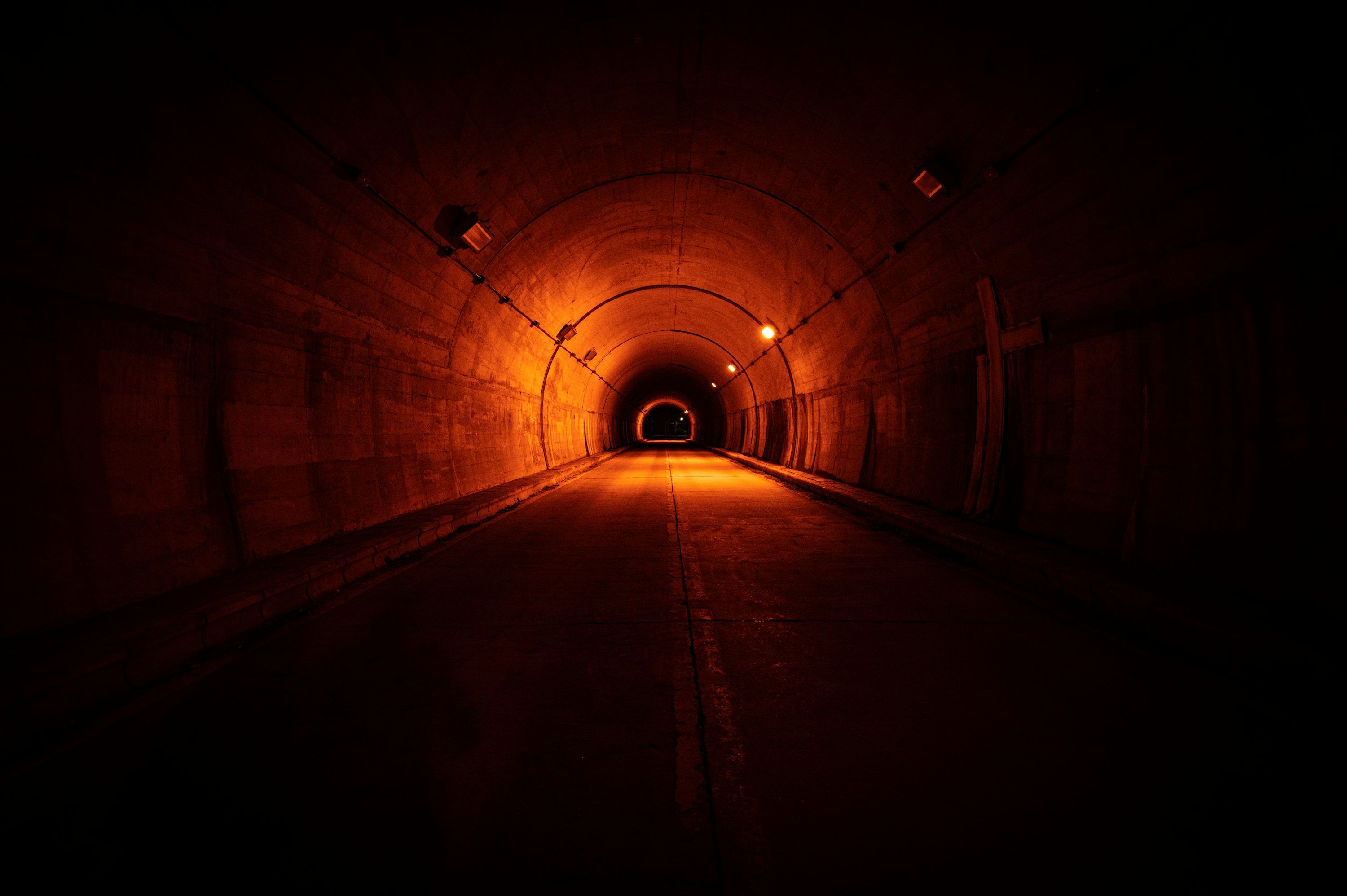 3000x1996 Tunnel with light turned on during night time photo