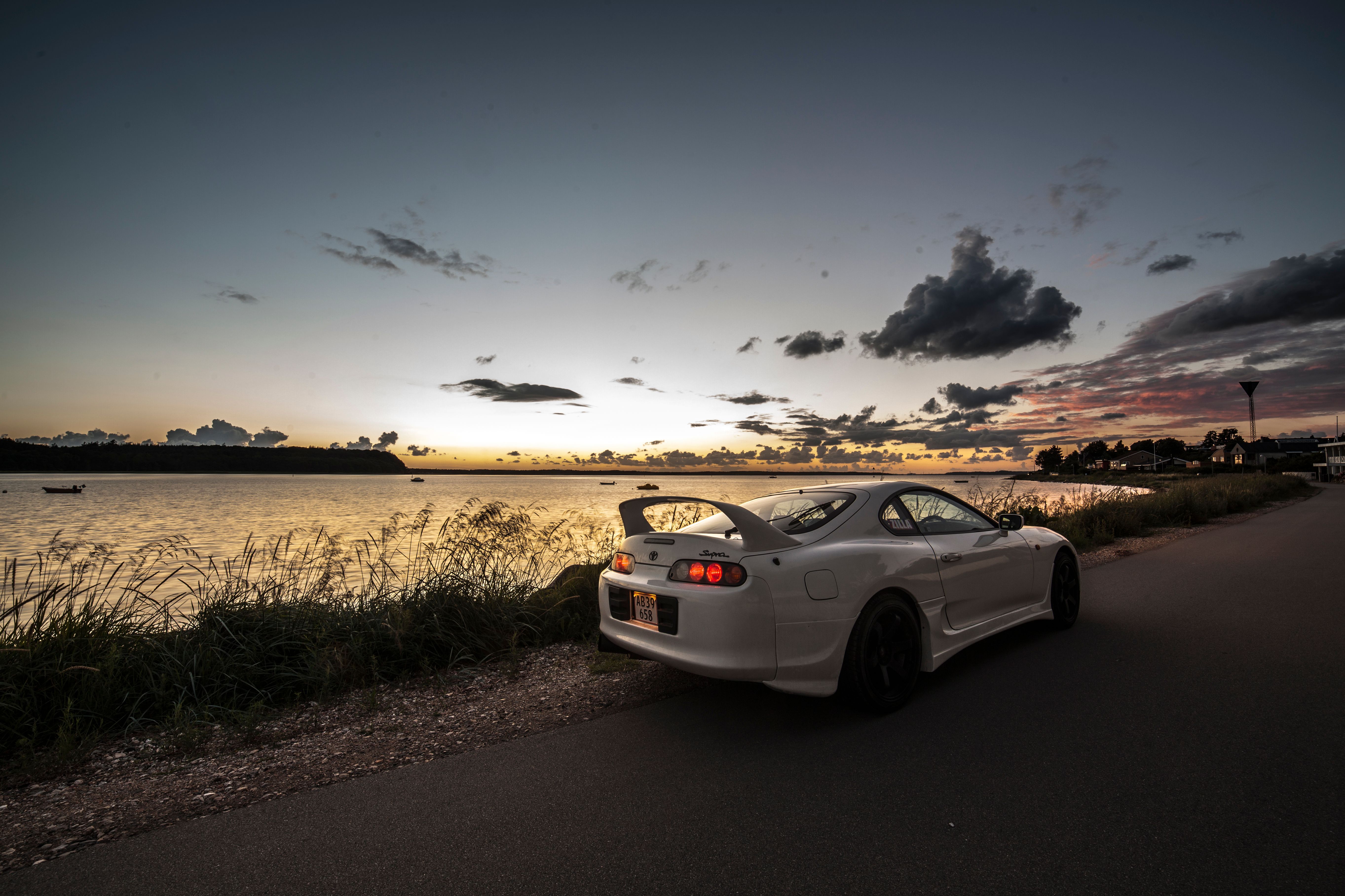 5452x3635 White Toyota Supra on Sea Shore at Sunset · Free