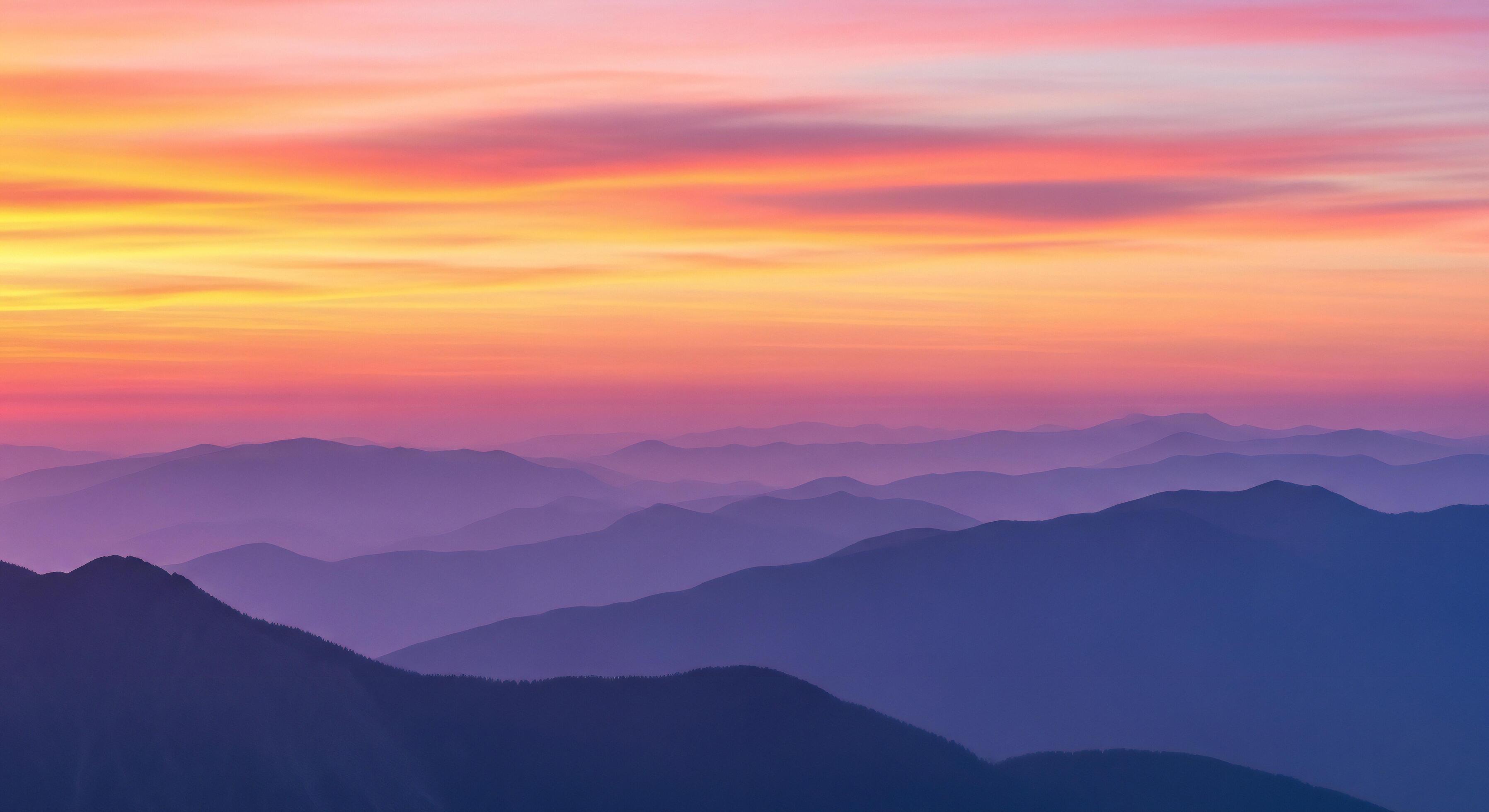 3593x1960 Nature background, Nature wallpaper, Layered purple mountain ranges fade into a vibrant sky painted with pink and orange sunset clouds