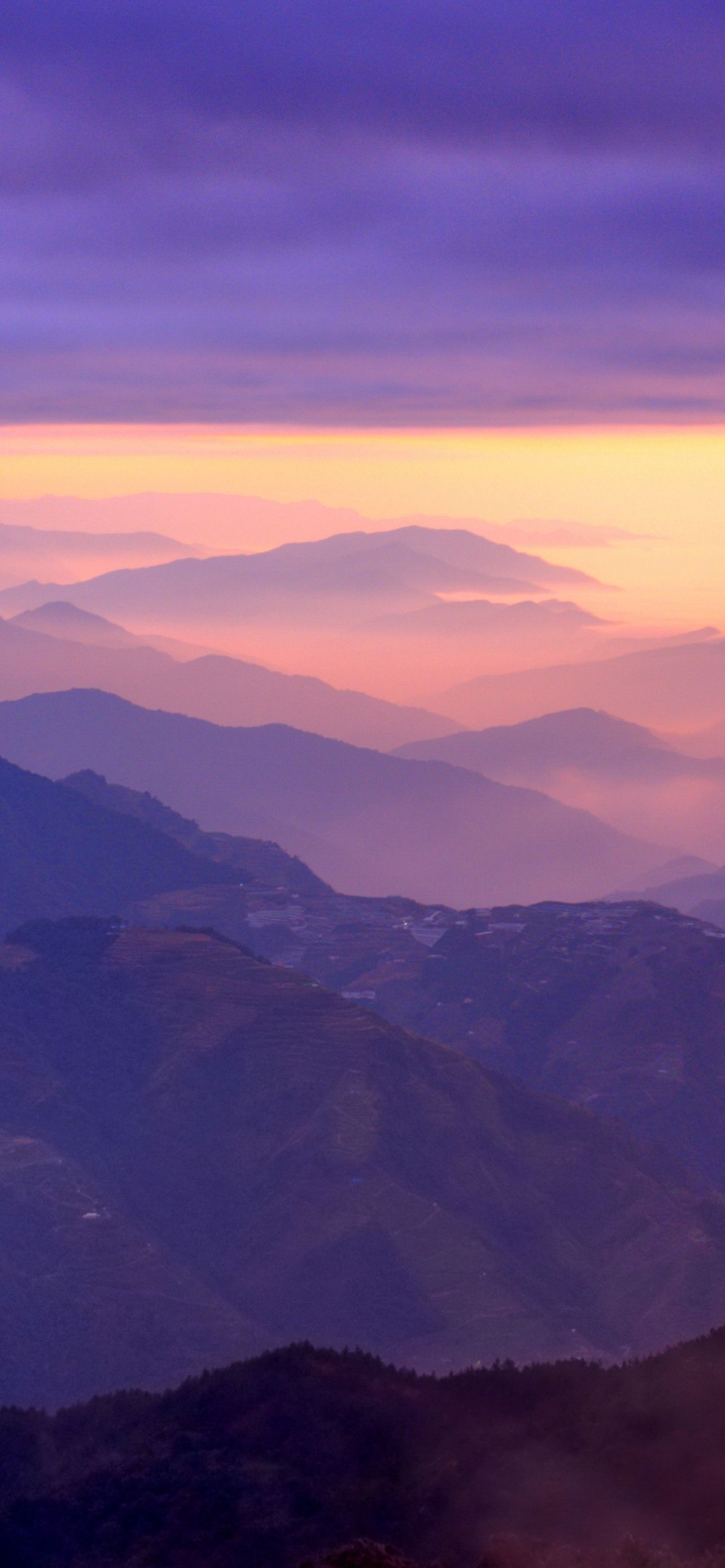 1284x2778 Mountain Range Sunset Purple Sky Foggy Clouds Landscape