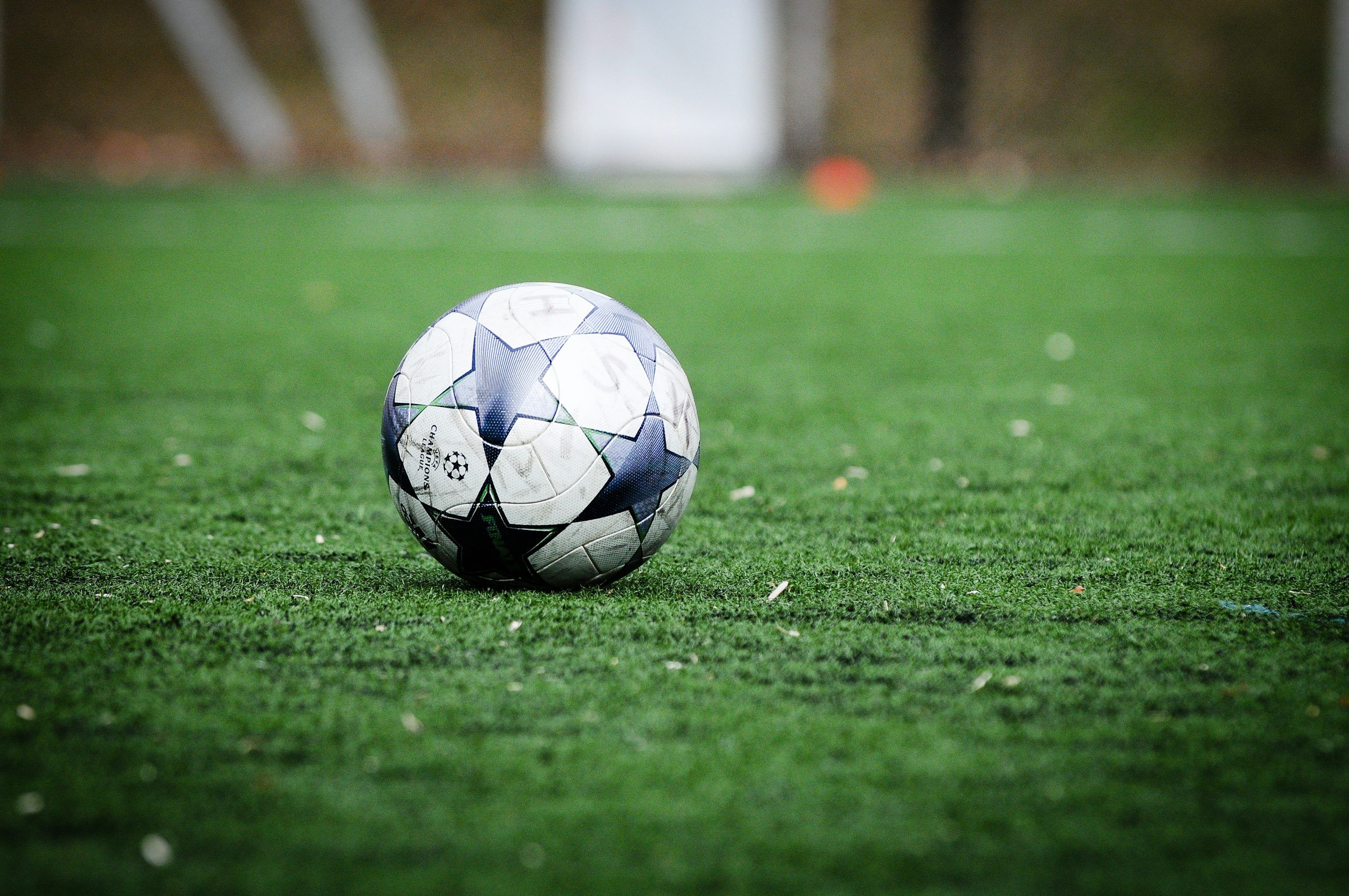 3000x1993 White and blue soccer ball on green grass field during daytime photo