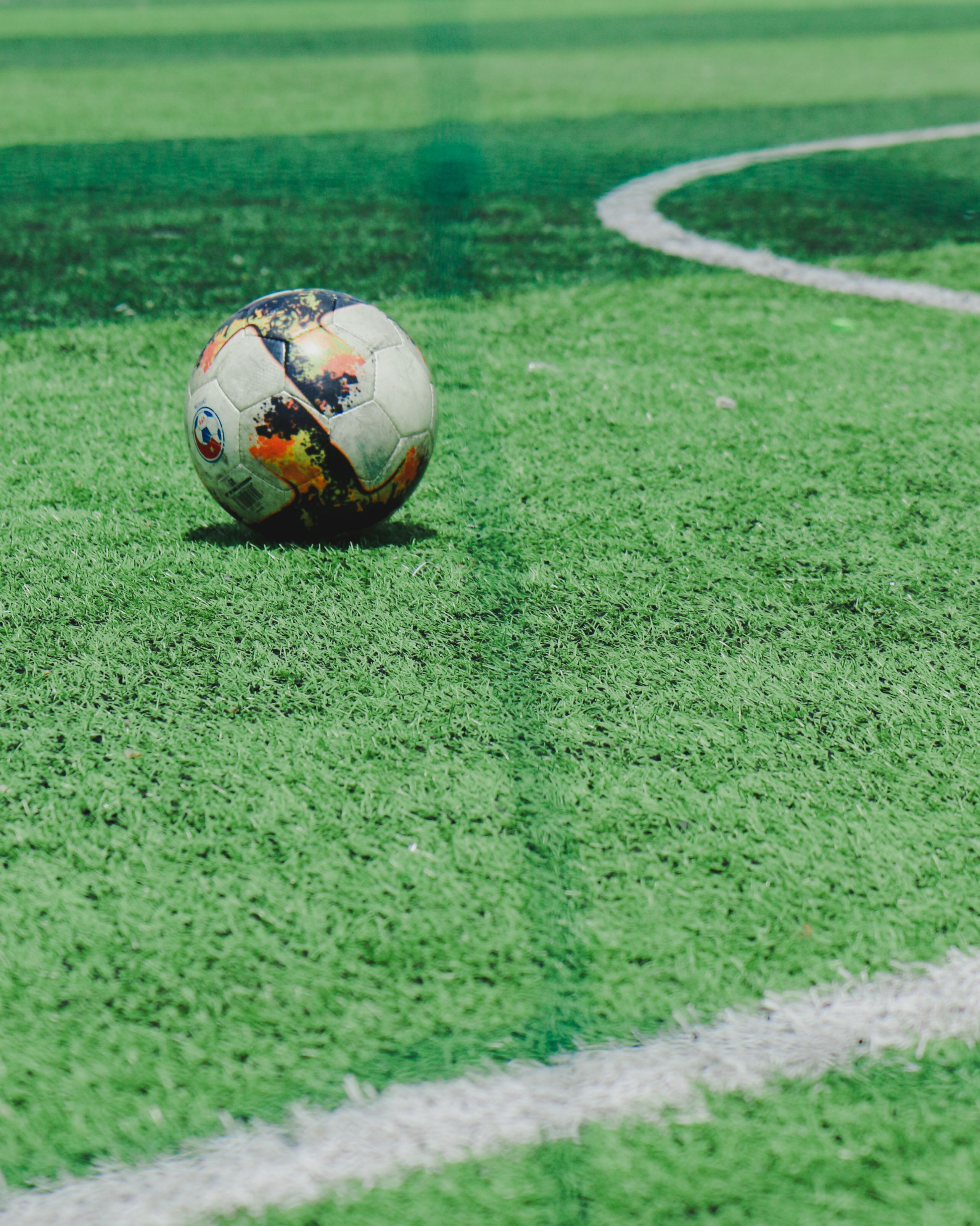 2569x3211 Soccer Ball Lying on a Soccer Field · Free